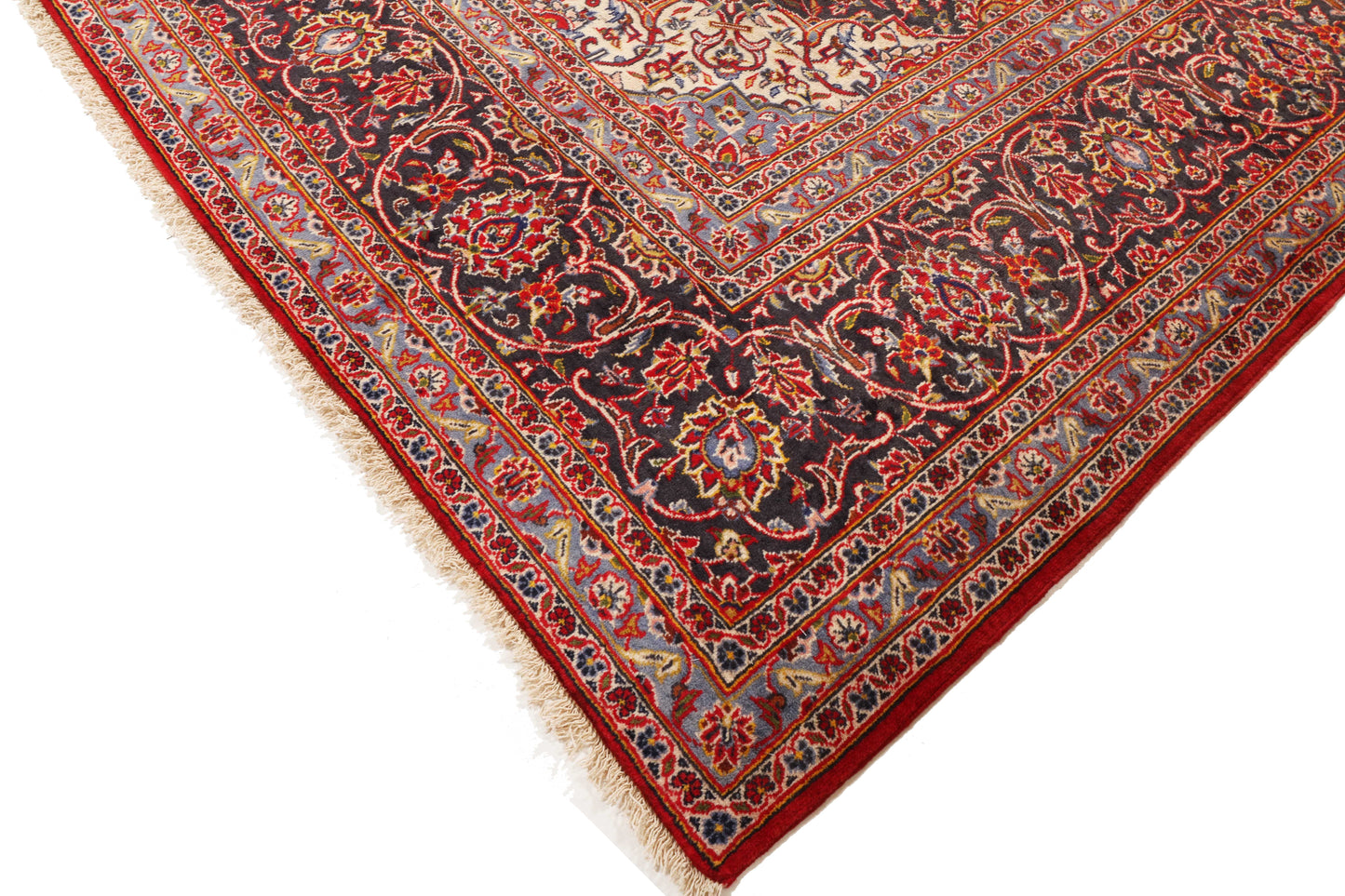 Close-up of a red and gold patterned rug on a white background