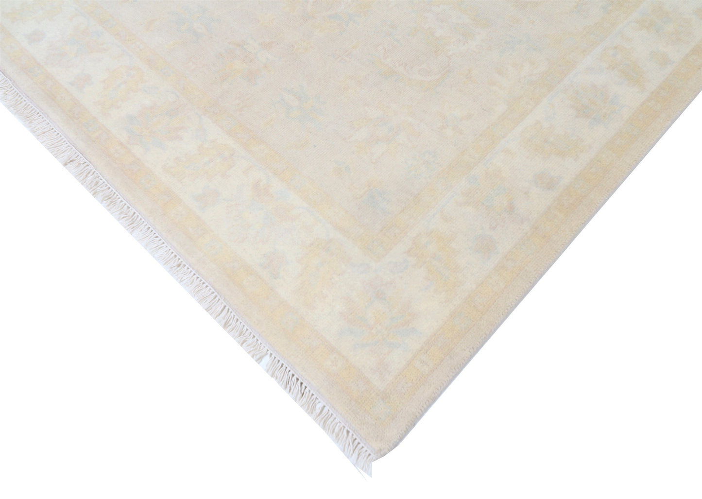Beige rug with a subtle pattern on a white background