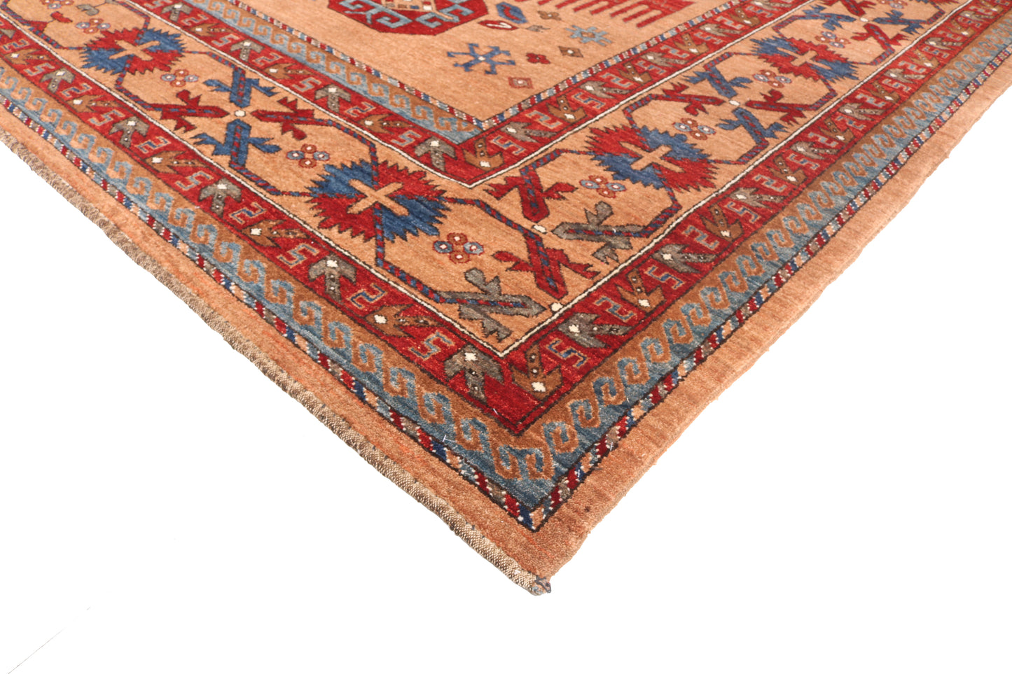 Close-up of a patterned rug with intricate designs on a white background