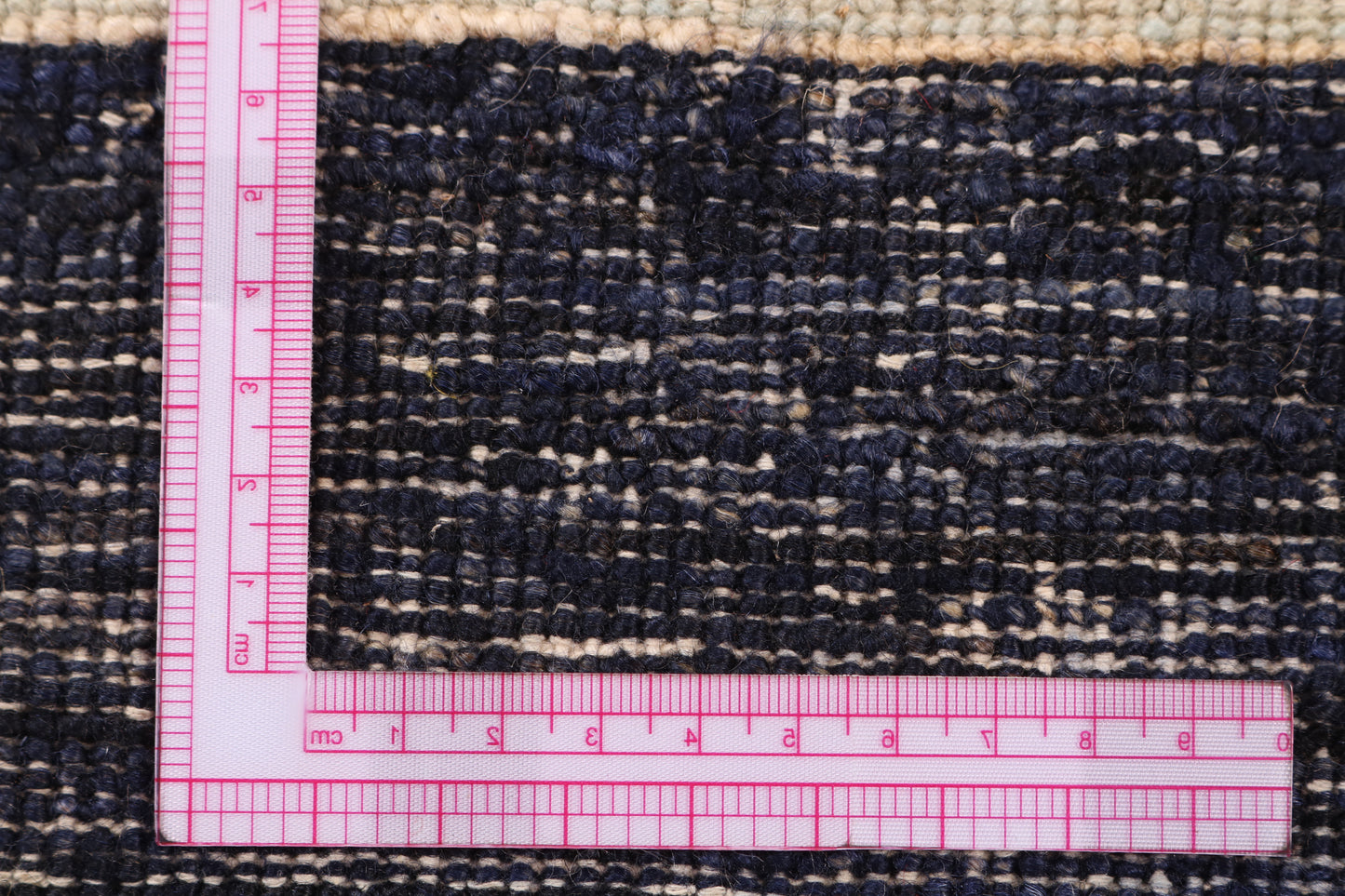 Rug with a pink measuring ruler on top