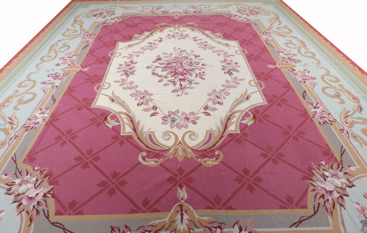 Decorative rug with floral patterns and geometric design on a pink background