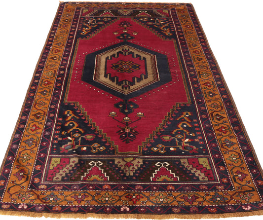 8x4ft antique traditional runner rug for hire, showing the saturated red field and historic geometric patterns suitable for event walkways and film sets.
