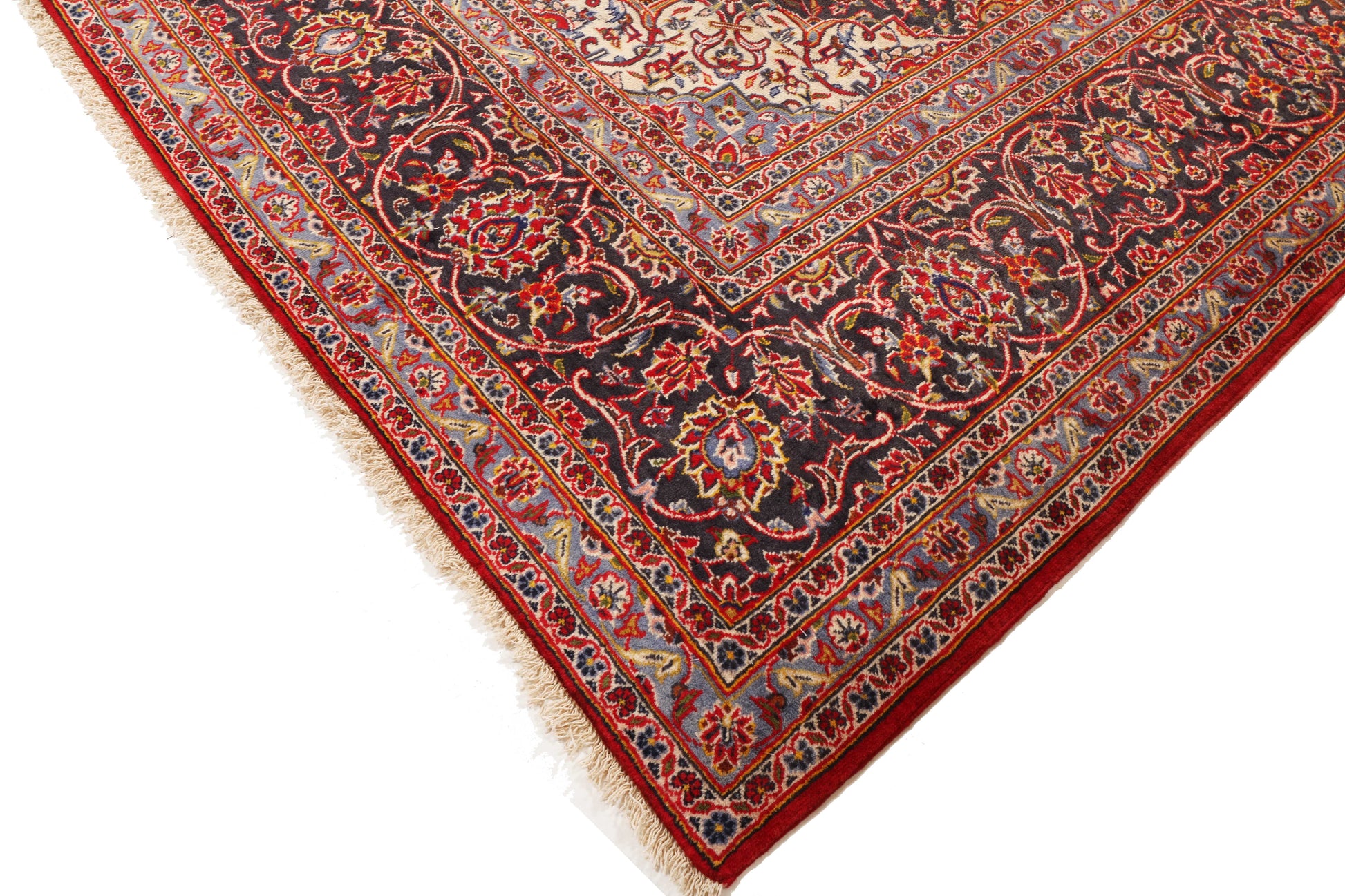 Close-up of a red and gold patterned rug on a white background