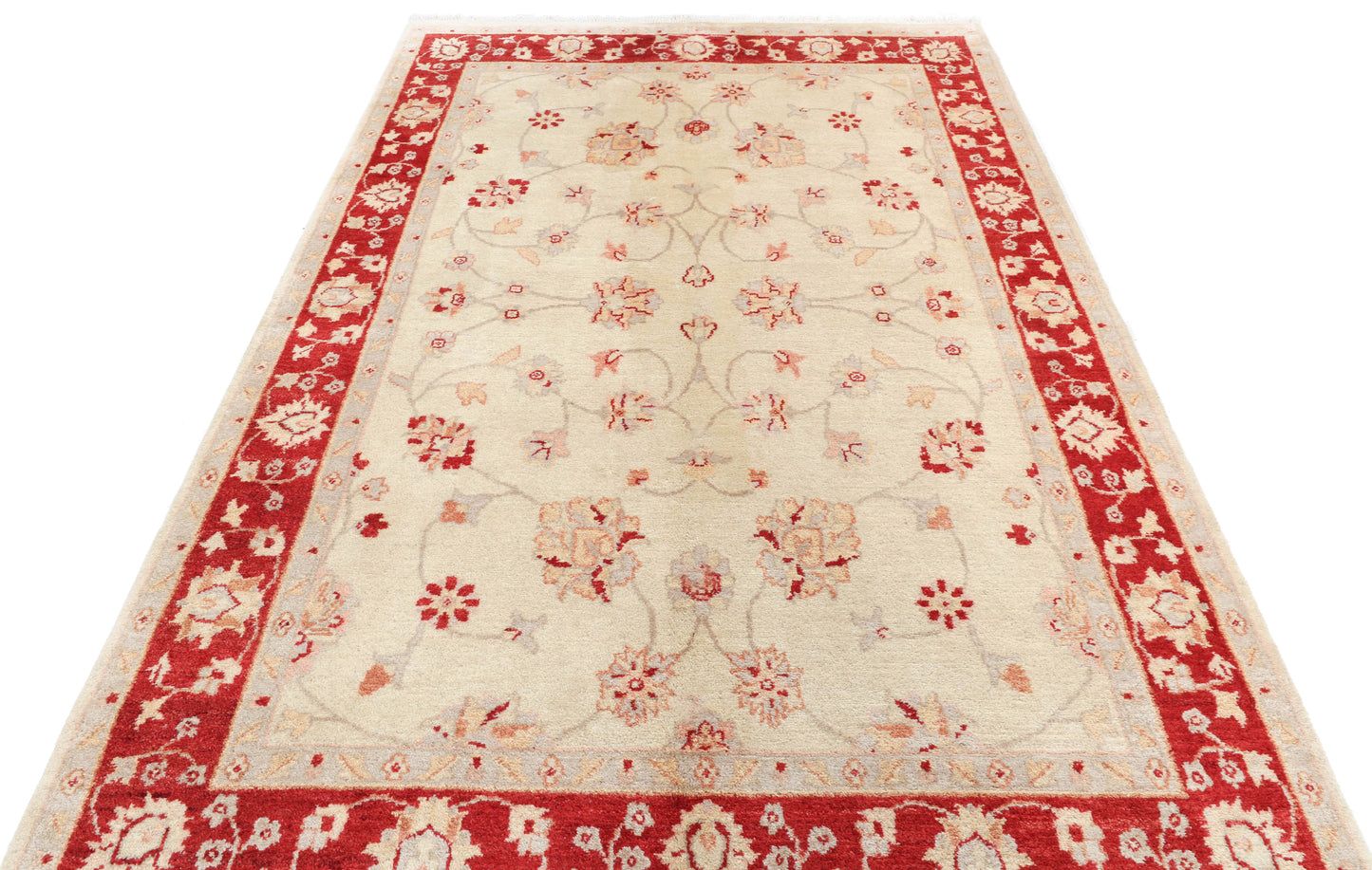 Decorative rug with red and beige pattern on a white background