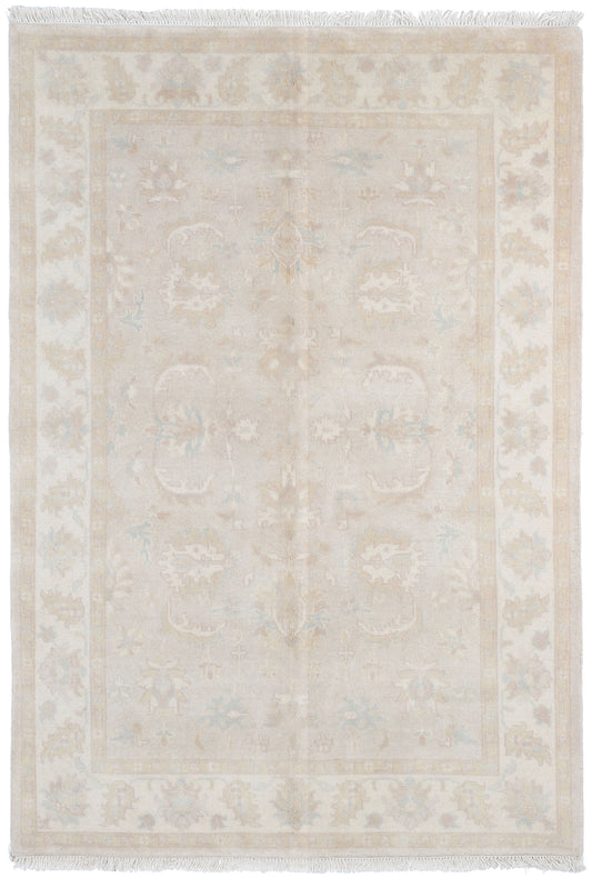 Beige area rug with subtle pattern on a white background