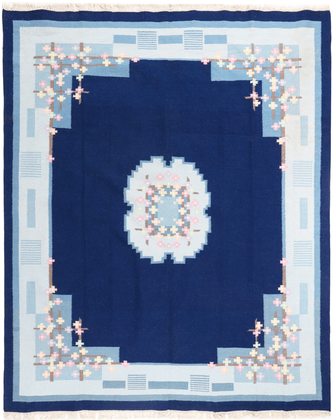 Quilt with a blue center and decorative border on a white background