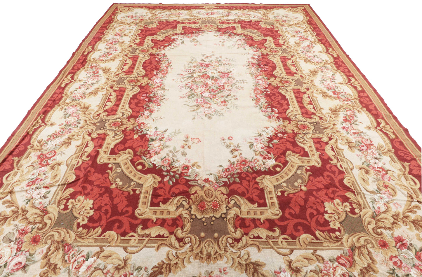 Decorative red and gold patterned rug on a white background