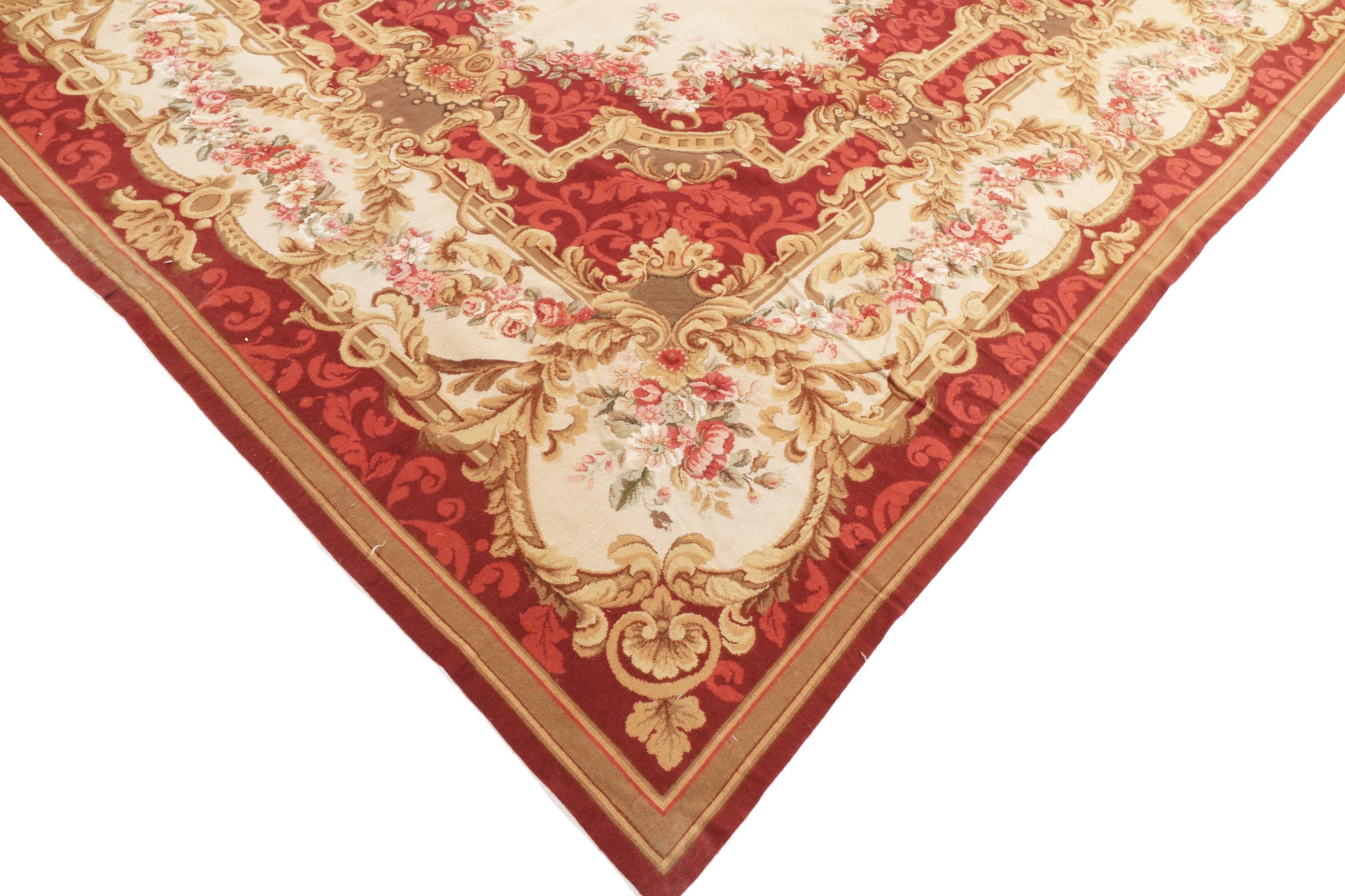 Decorative red and gold patterned rug on a white background