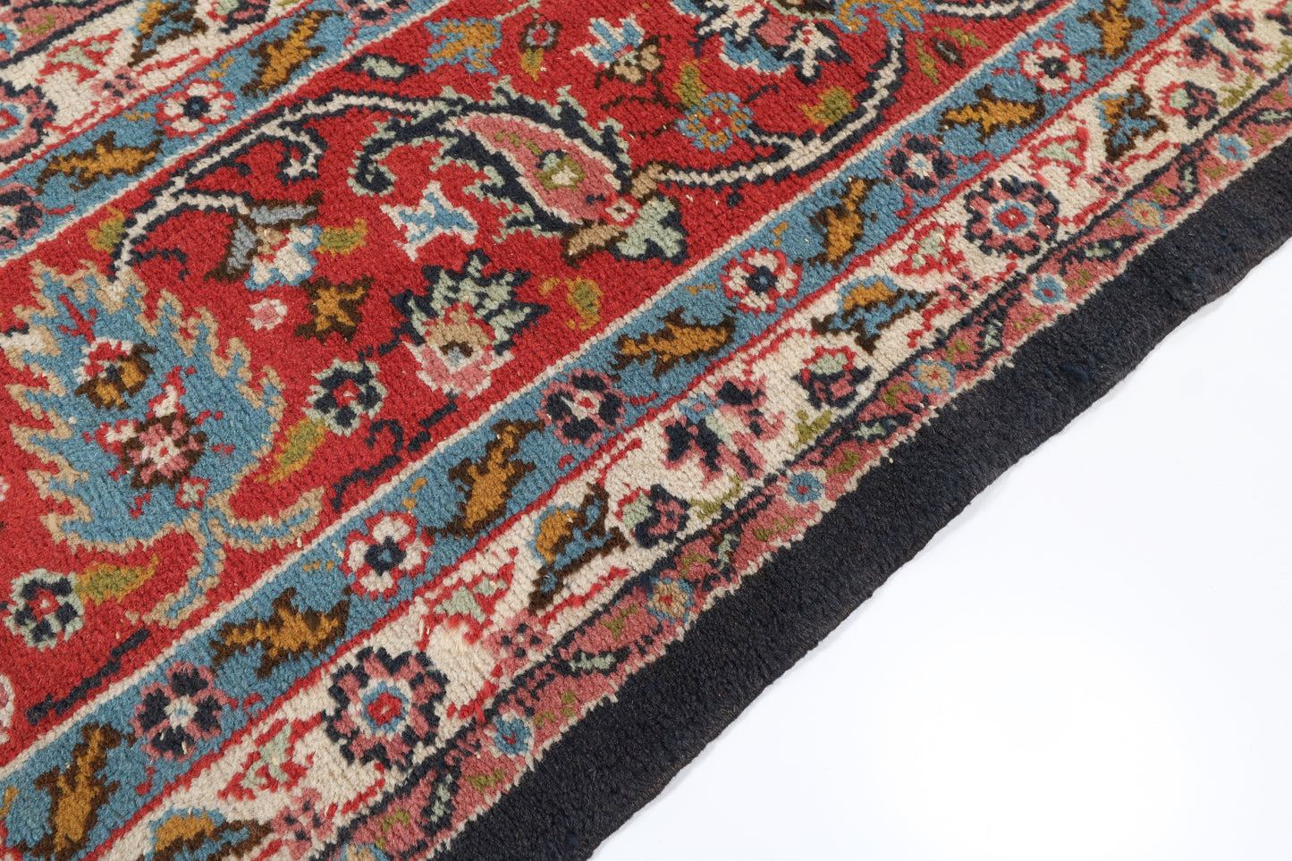 Close-up of a colorful patterned rug with intricate designs on a white background