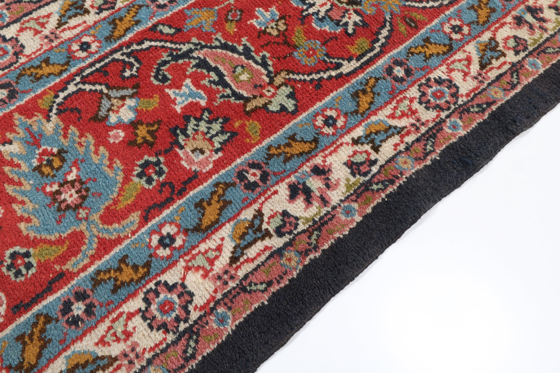 Close-up of a colorful patterned rug with intricate designs on a white background