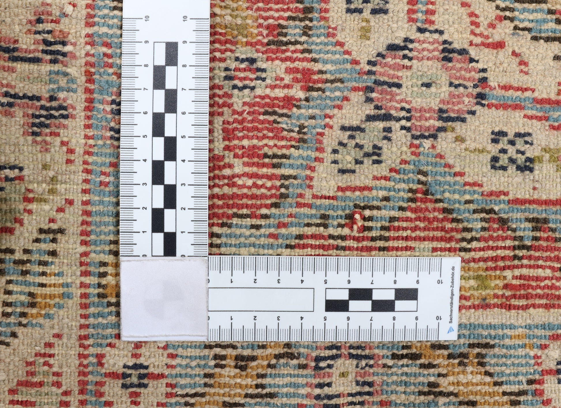 Multicolored patterned rug with a ruler for scale