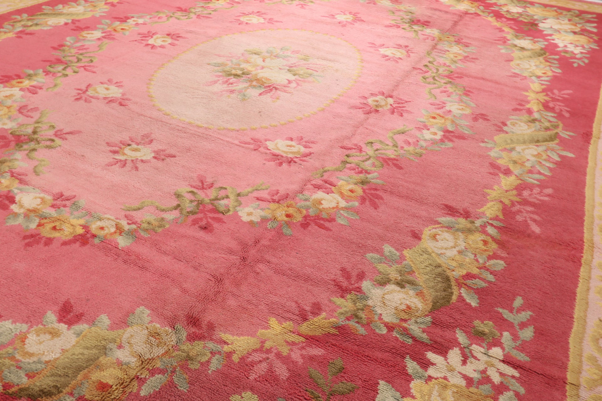 Detailed view of the plush 100% wool pile and intricate floral weaving of a Savonnerie style rug, highlighting the premium quality for luxury rentals.