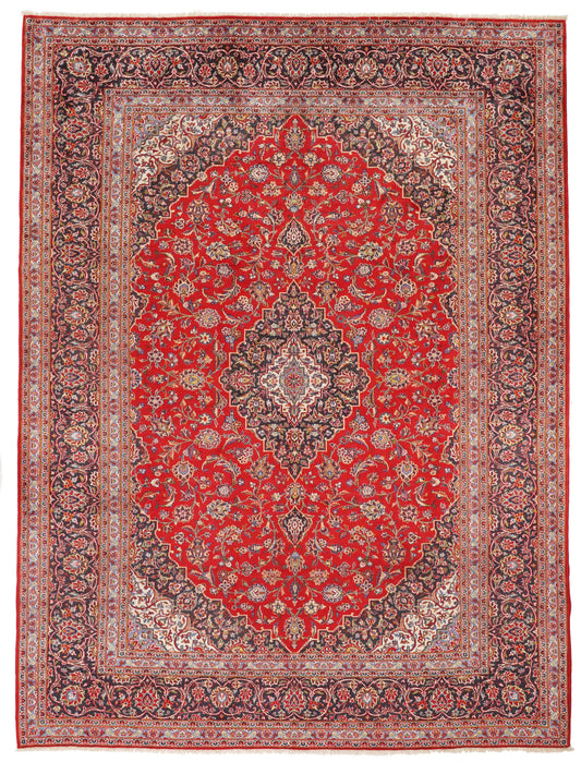 Full-view oversized Persian red and navy rug for hire, 404x300cm, hand-knotted wool, London film set and event rental