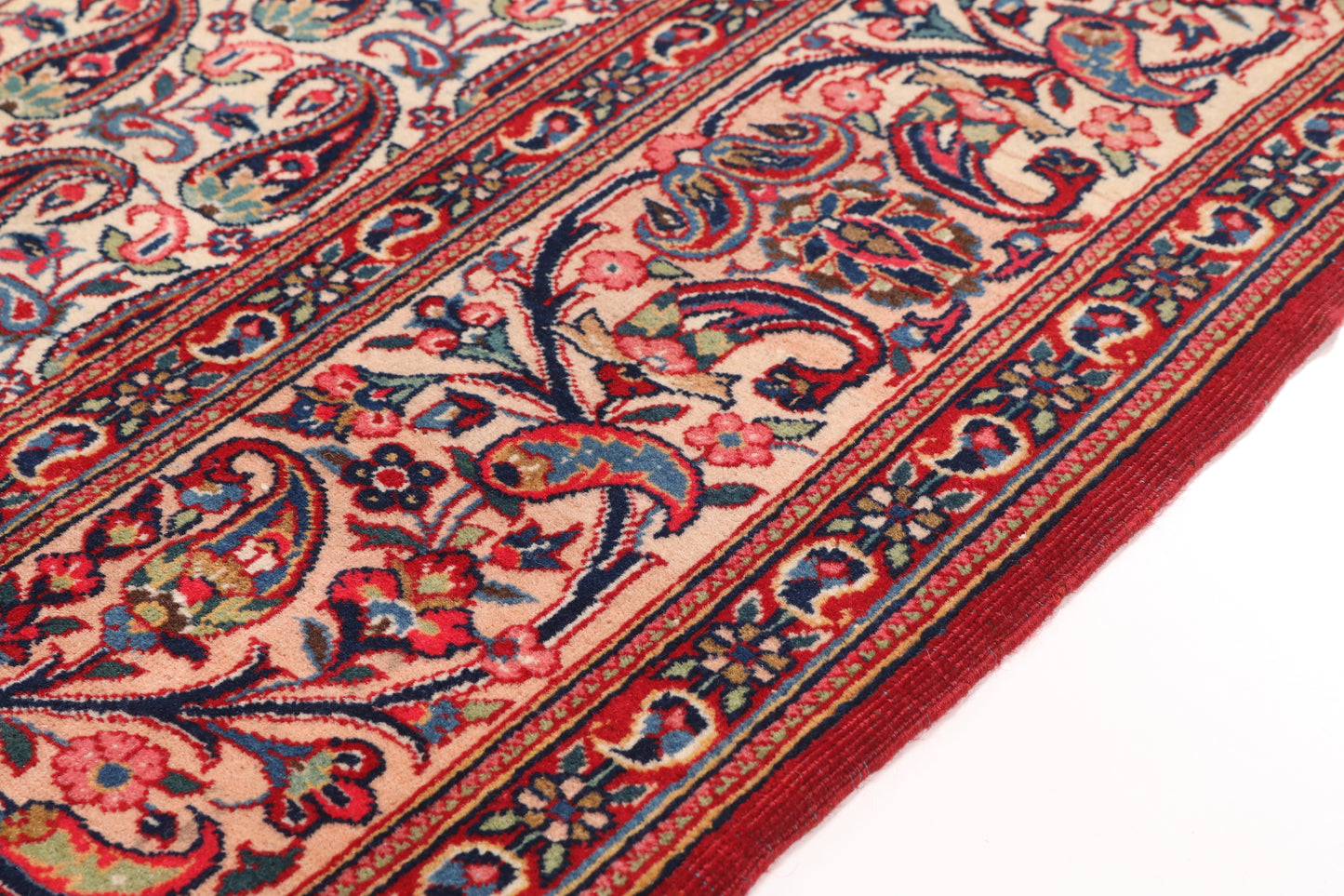 Close-up of a patterned rug with intricate designs on a white background