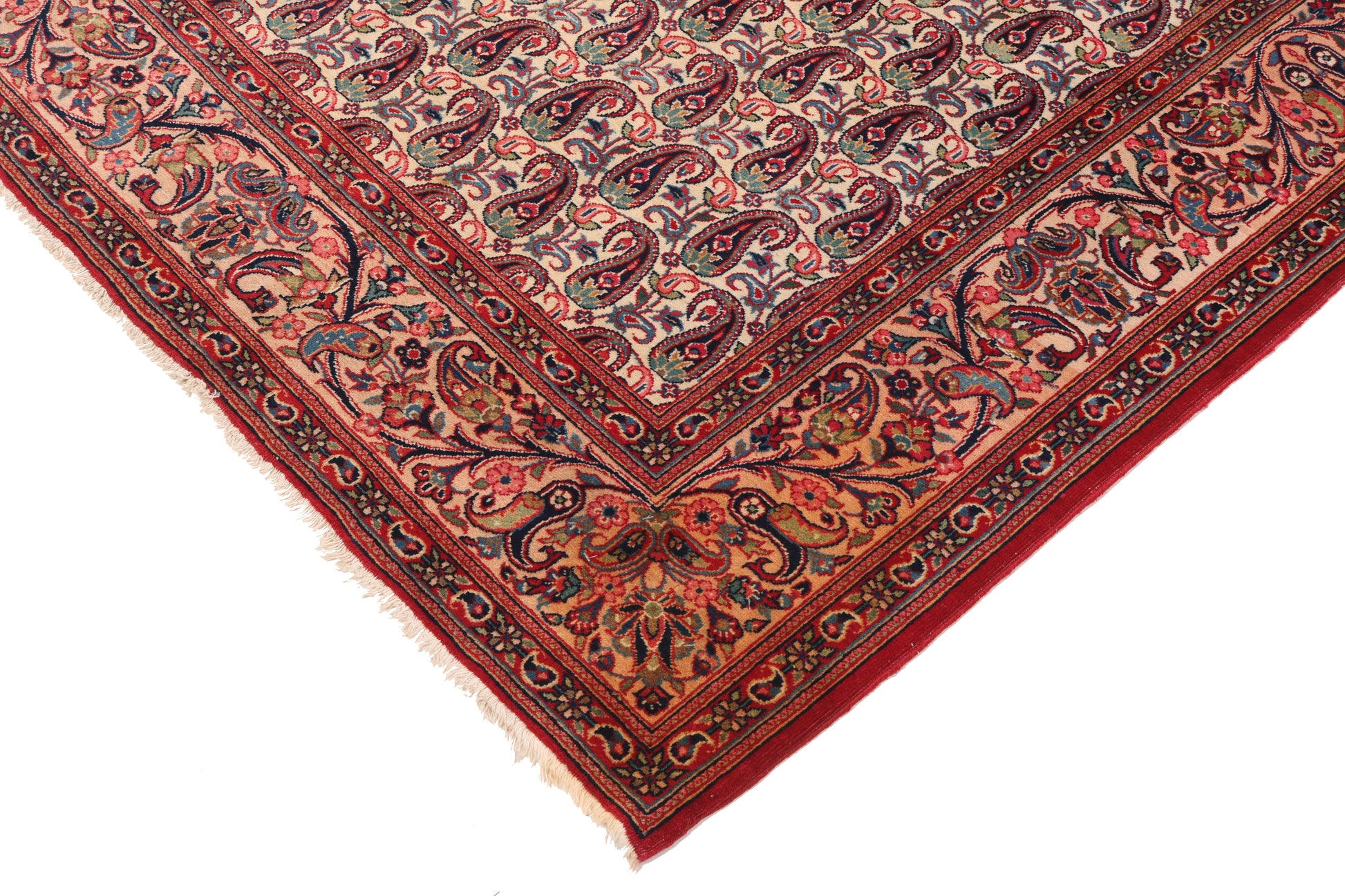 Close-up of a patterned red rug with intricate designs on a white background