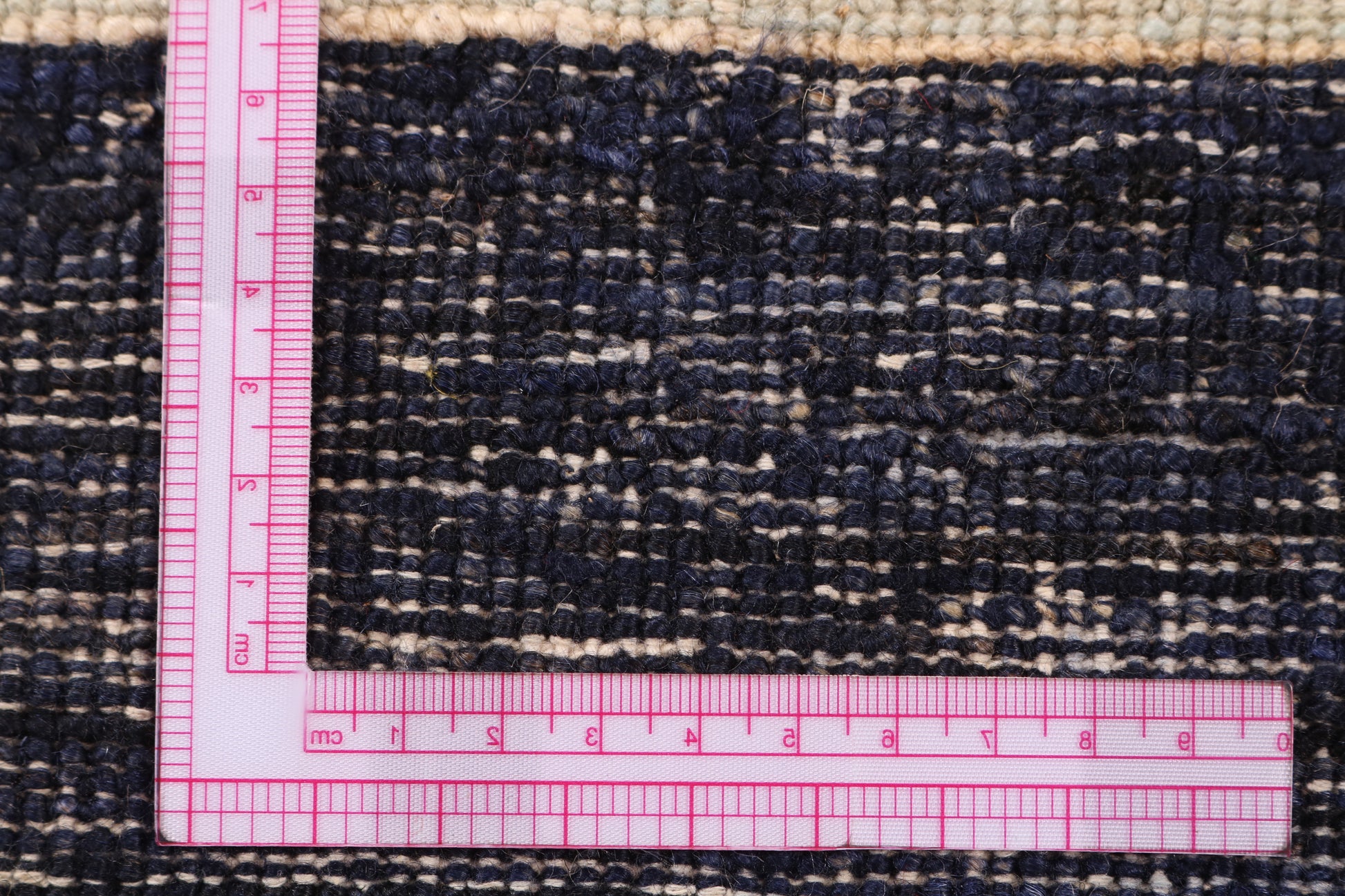Rug with a pink measuring ruler on top