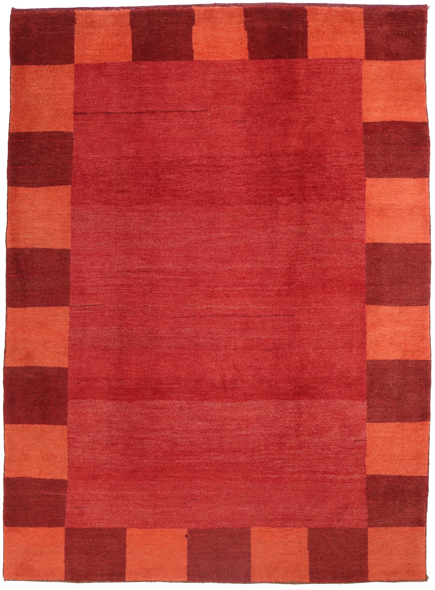Rectangular rug with a checkered pattern of red and orange squares.