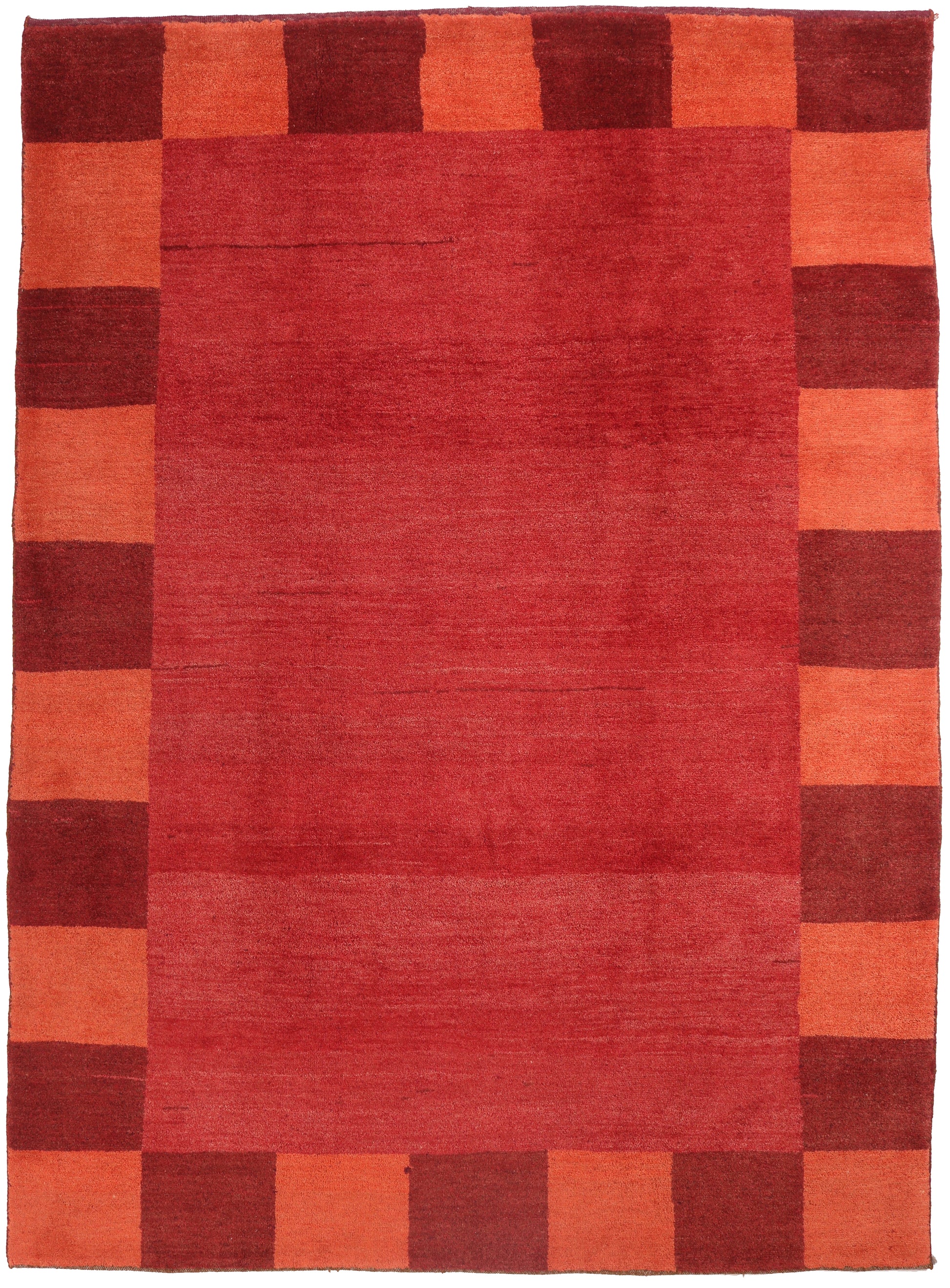 Rectangular rug with a checkered pattern of red and orange squares.