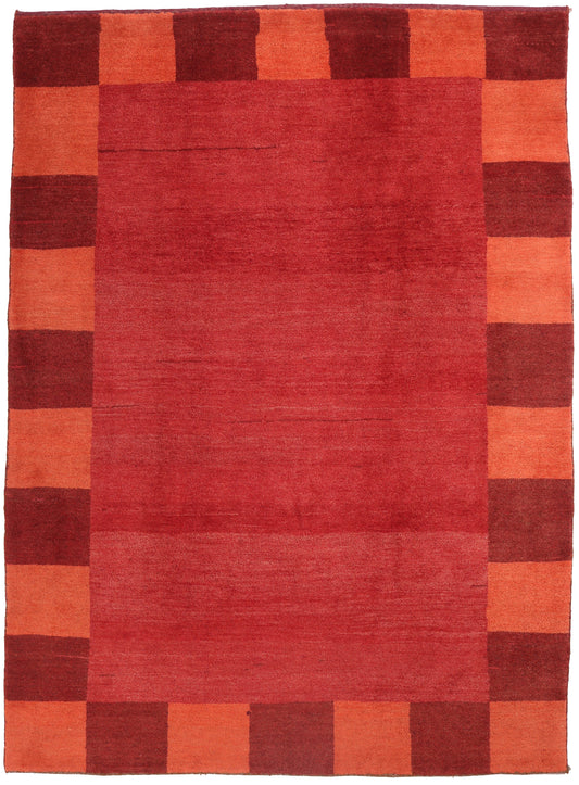 Rectangular rug with a checkered pattern of red and orange squares.