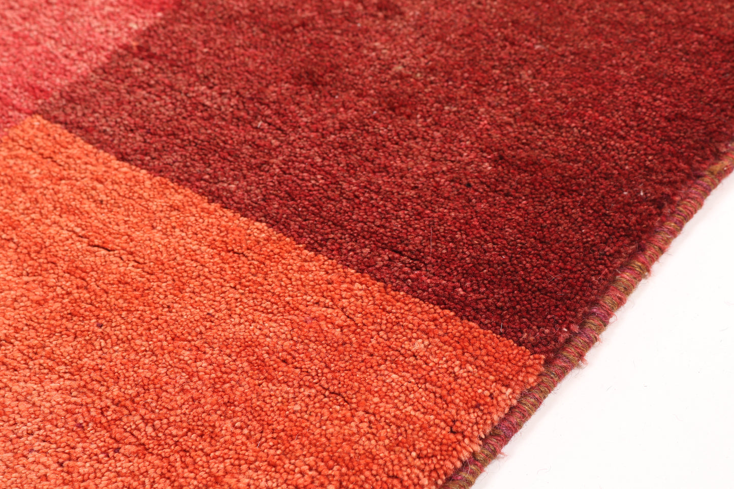 Close-up of a red and orange striped rug on a white background
