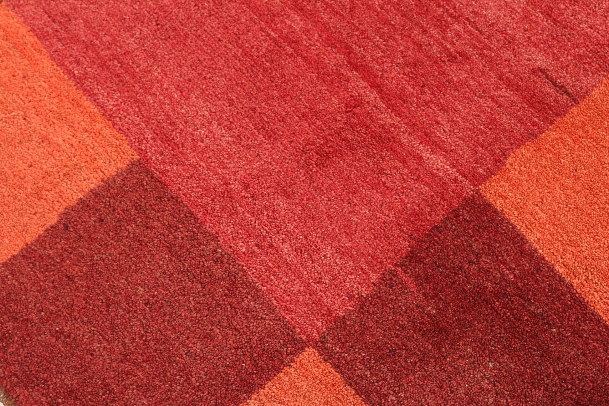 Close-up of a red and orange checkered patterned rug