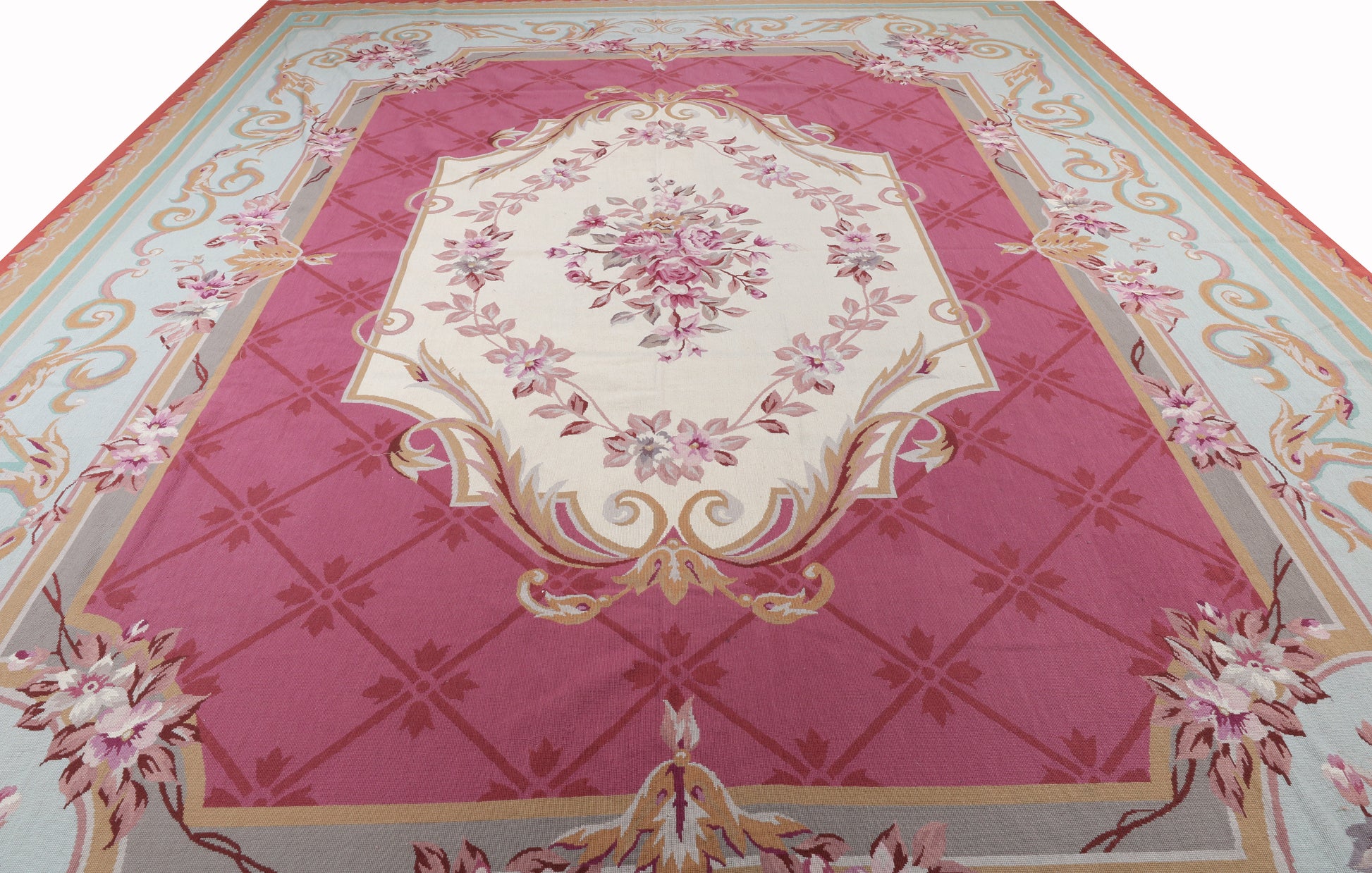 Decorative rug with floral patterns and geometric design on a pink background