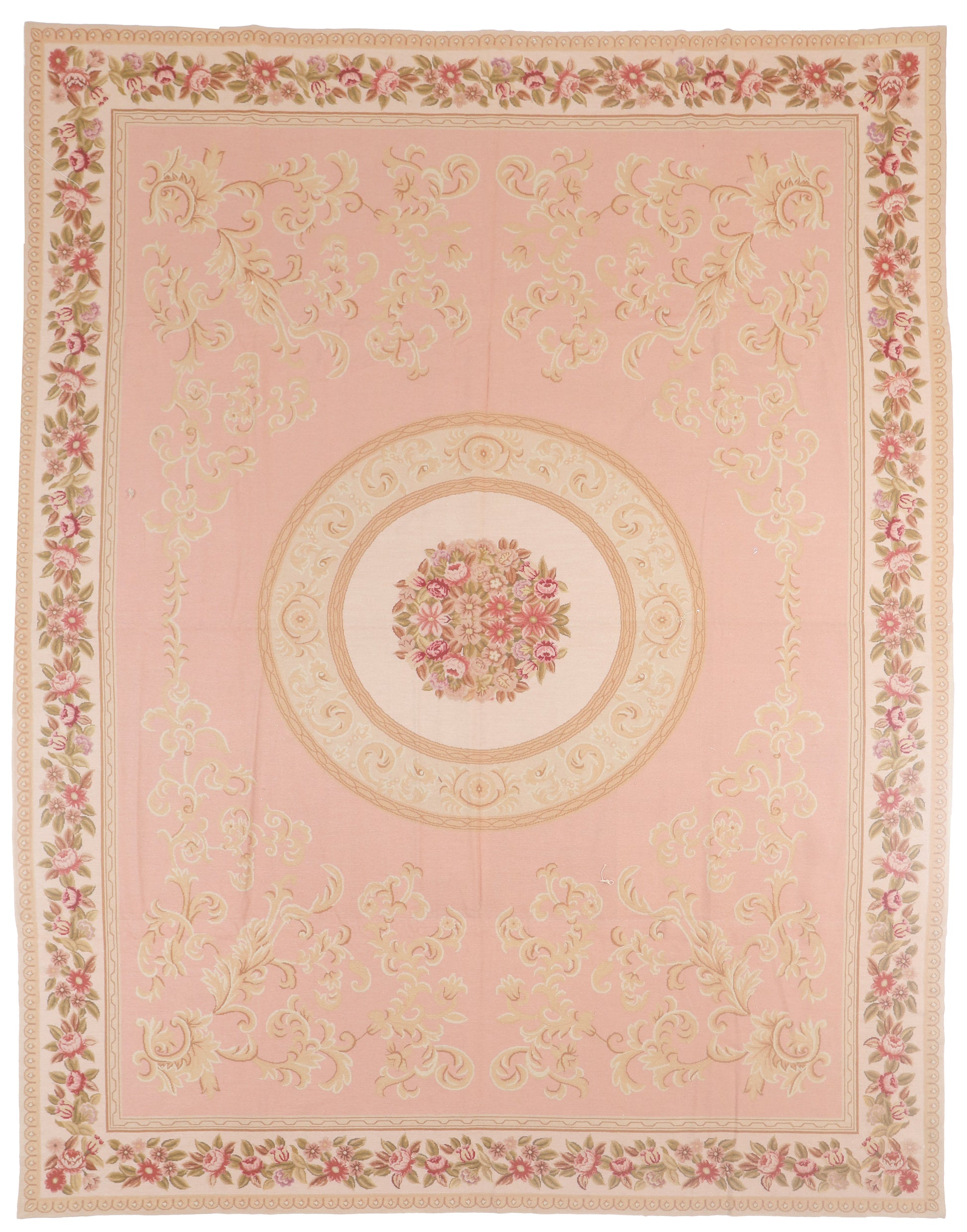 Decorative pink rug with floral patterns and a central medallion