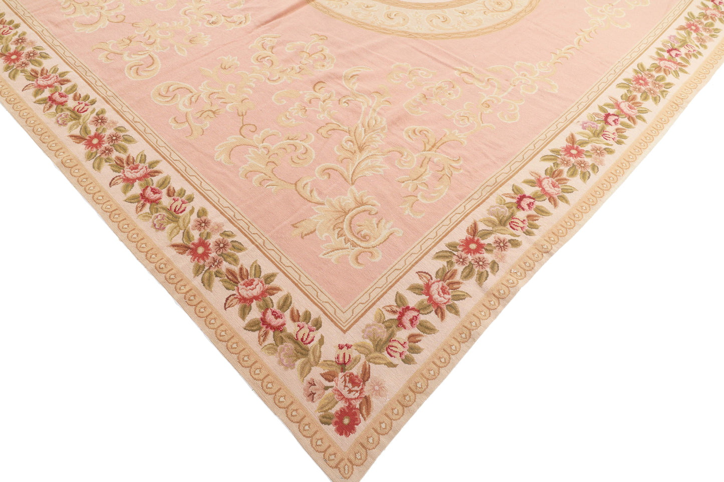 Decorative pink rug with floral patterns on a white background