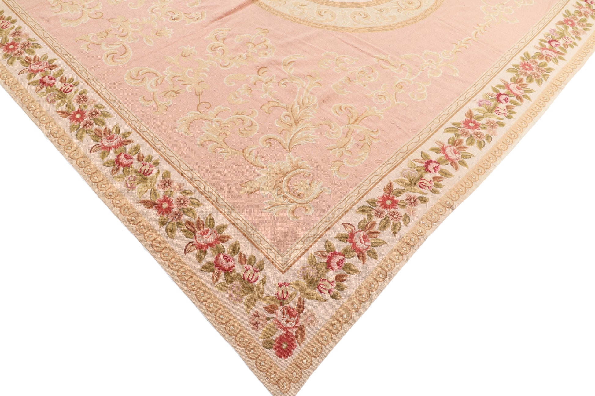 Decorative pink rug with floral patterns on a white background