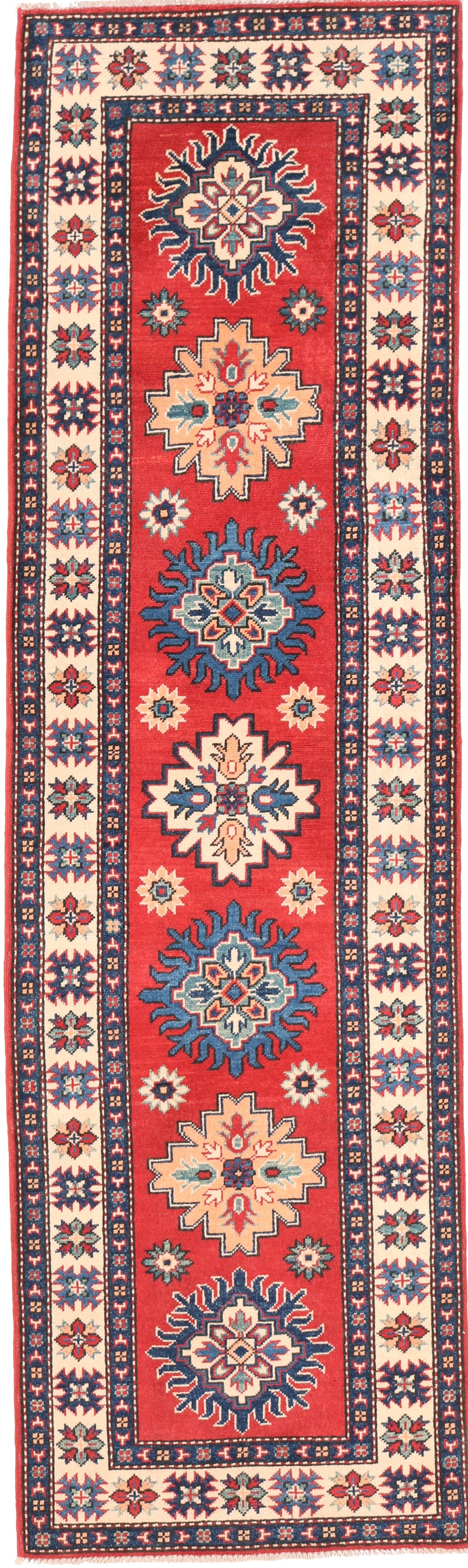 Decorative rug with geometric pattern on a red background