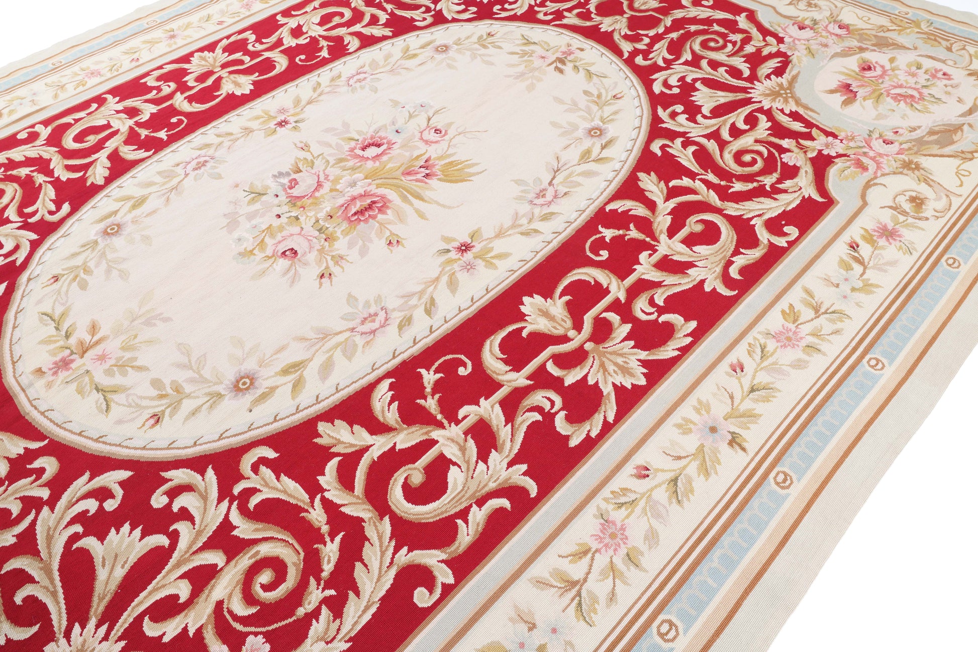 Decorative red and gold patterned rug with floral design