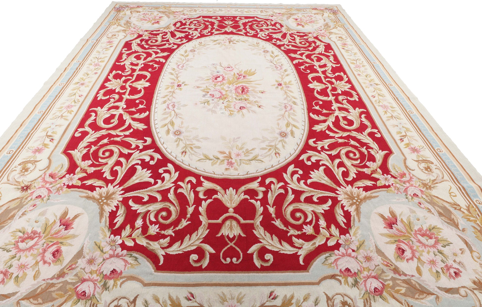 Decorative red and gold patterned rug with floral designs on a white background