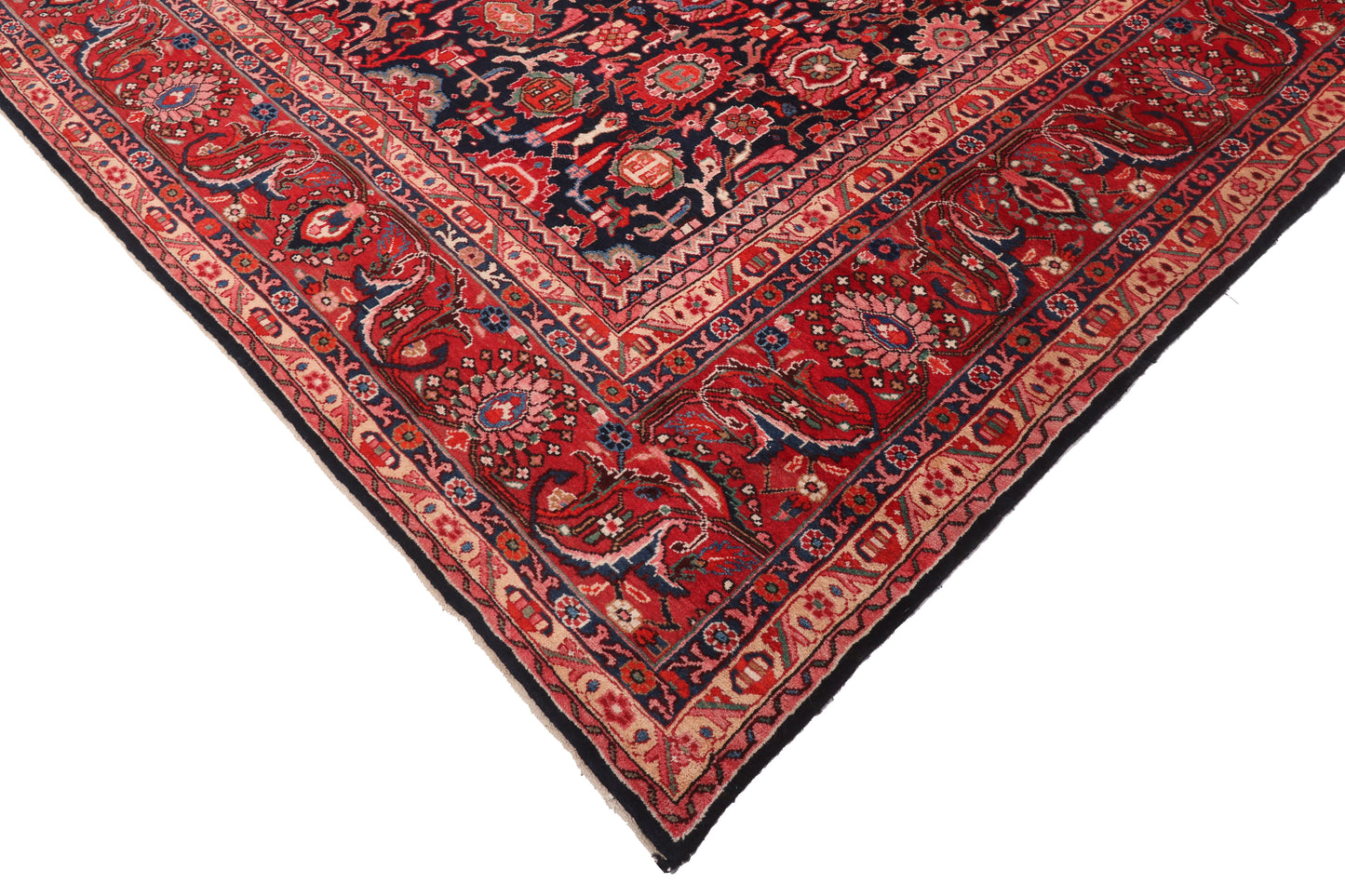 Close-up of a red and black patterned rug corner on a white background