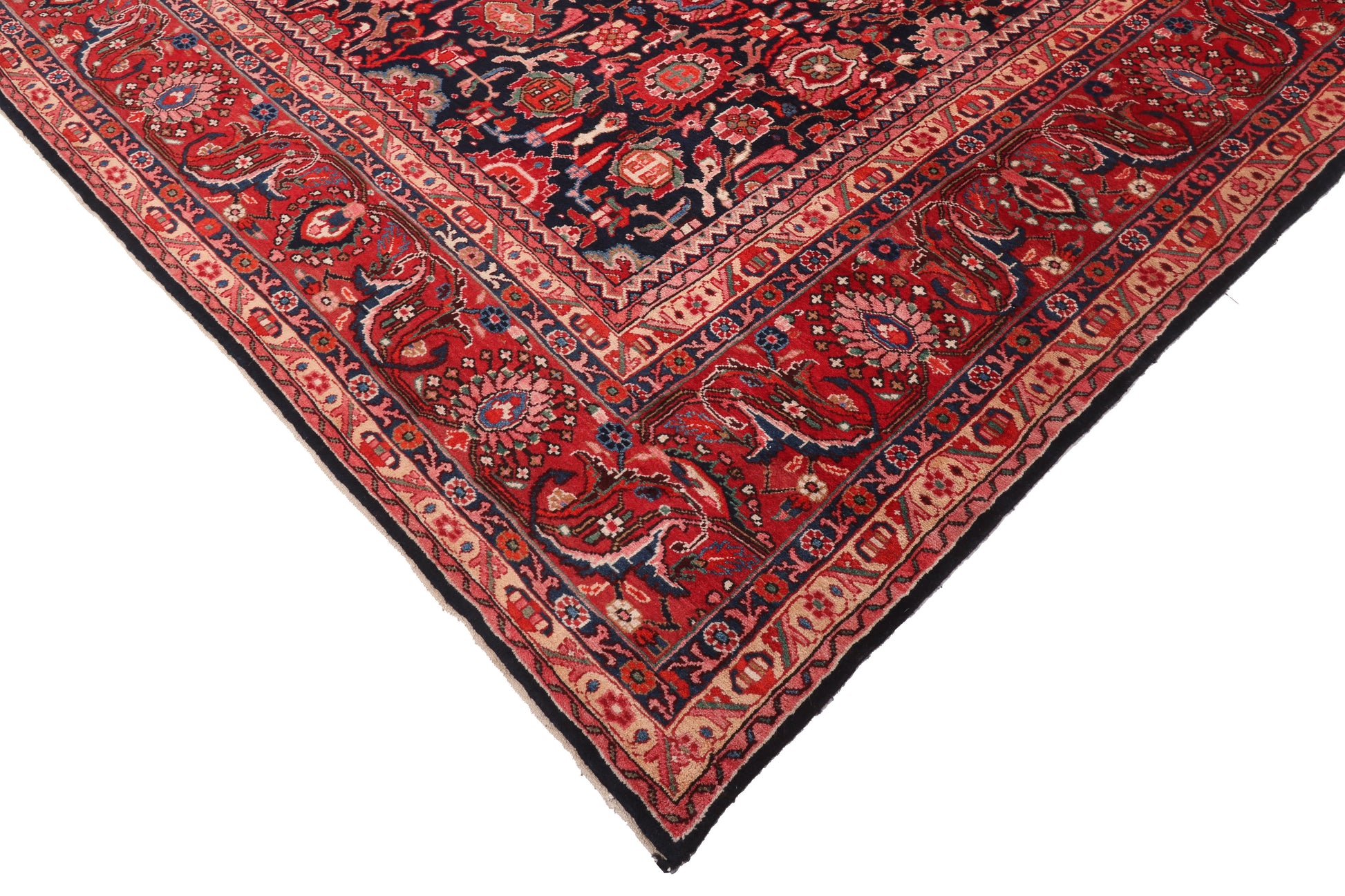 Close-up of a red and black patterned rug corner on a white background