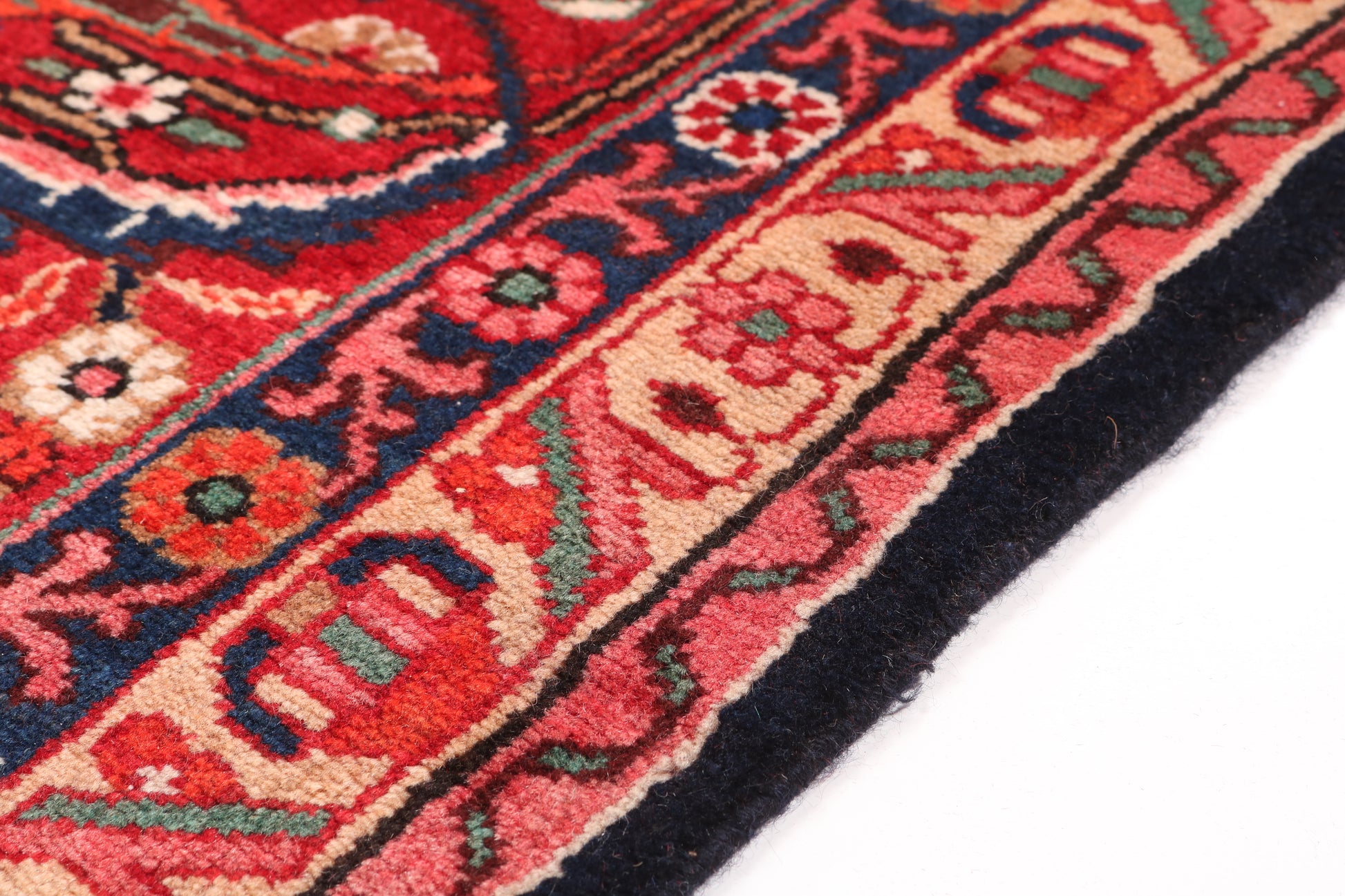Close-up of a red and black patterned rug corner