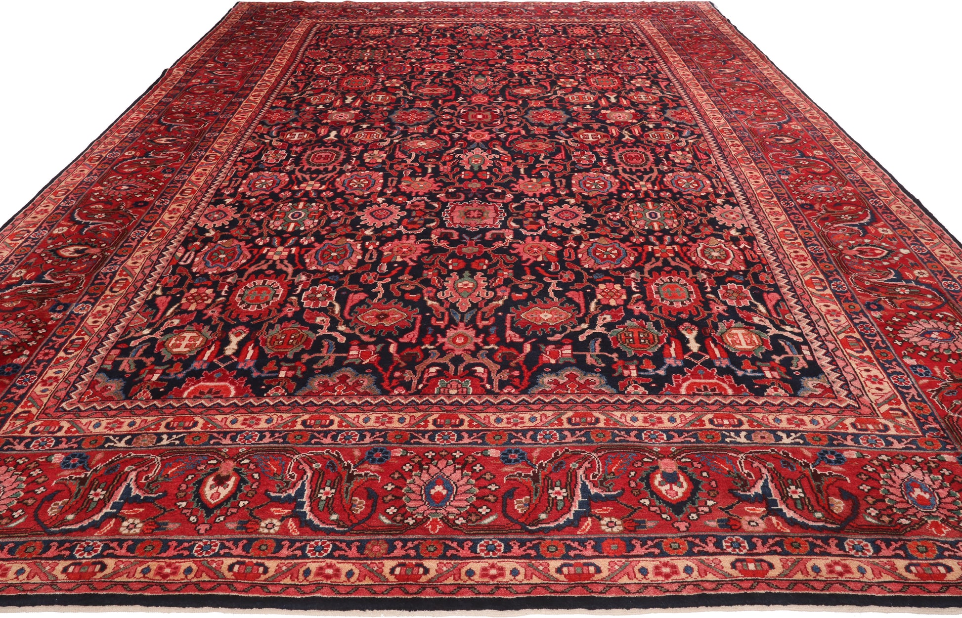 Traditional red and black patterned rug on a white background