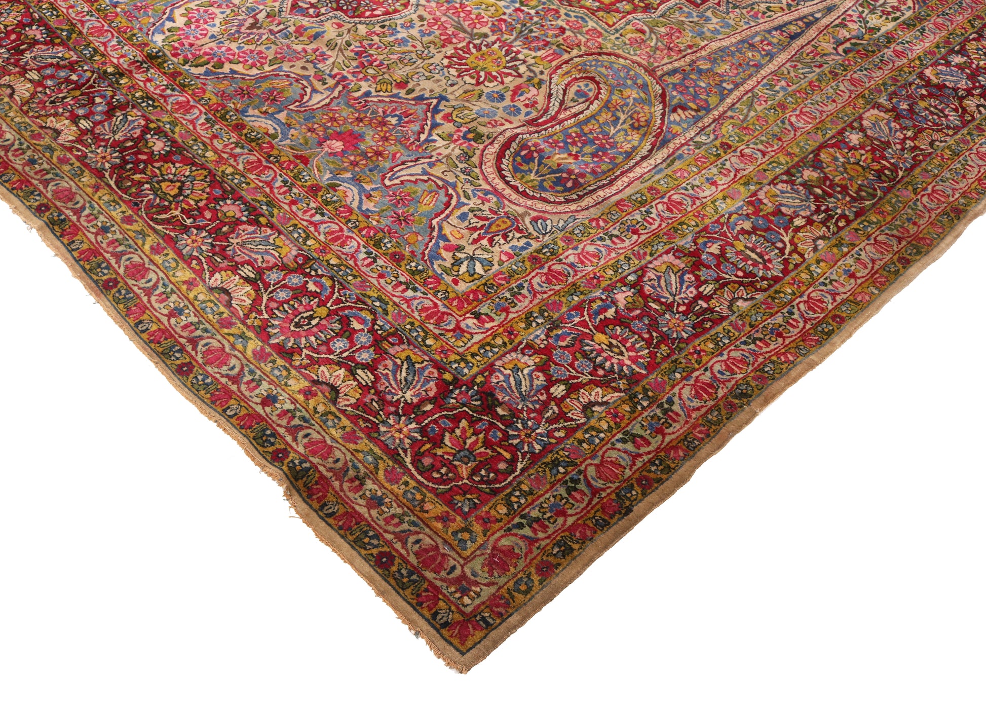 Detailed corner view of a hand-knotted traditional antique rug highlighting the fine floral patterns and historic craftsmanship.