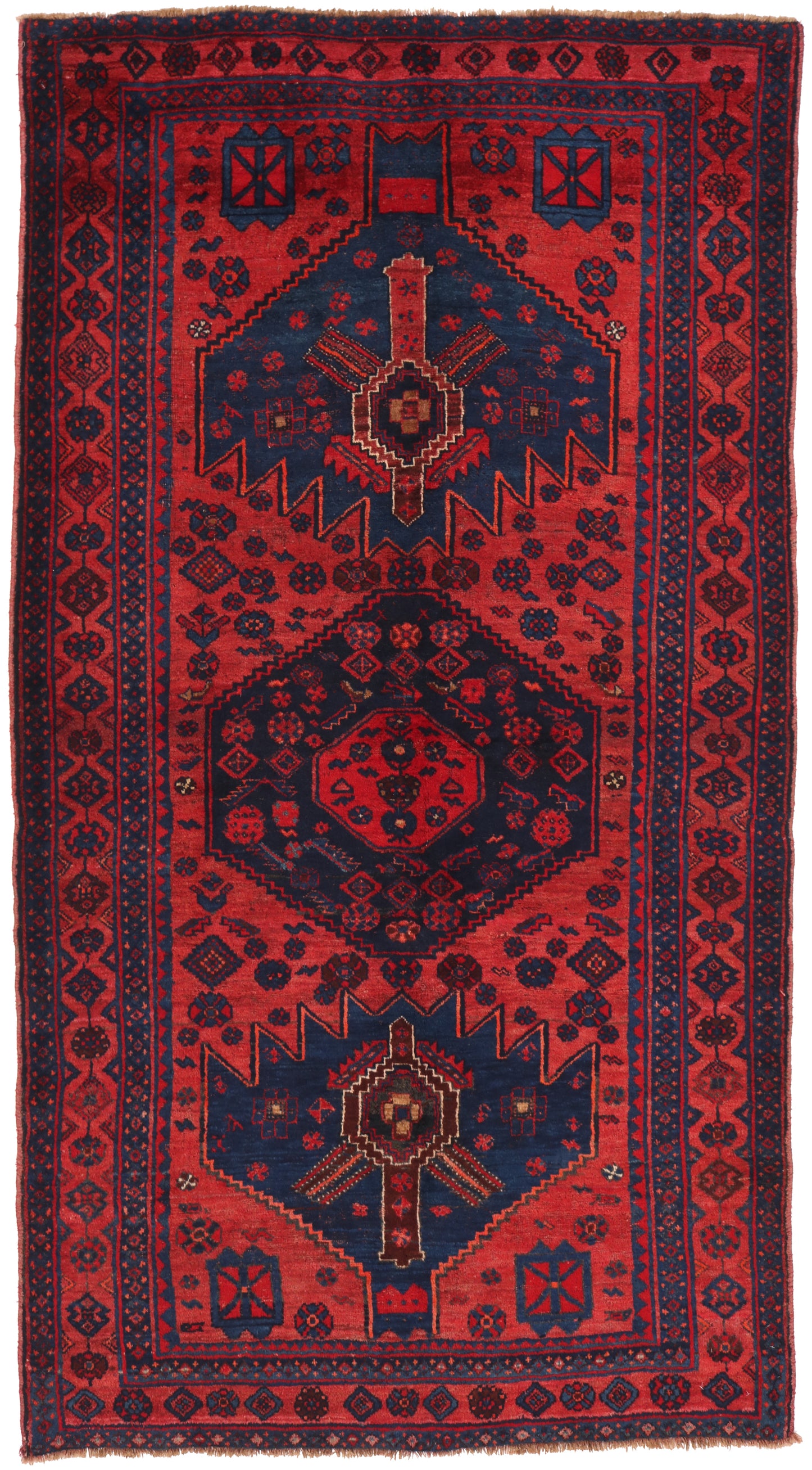 Red and blue patterned rug with geometric design