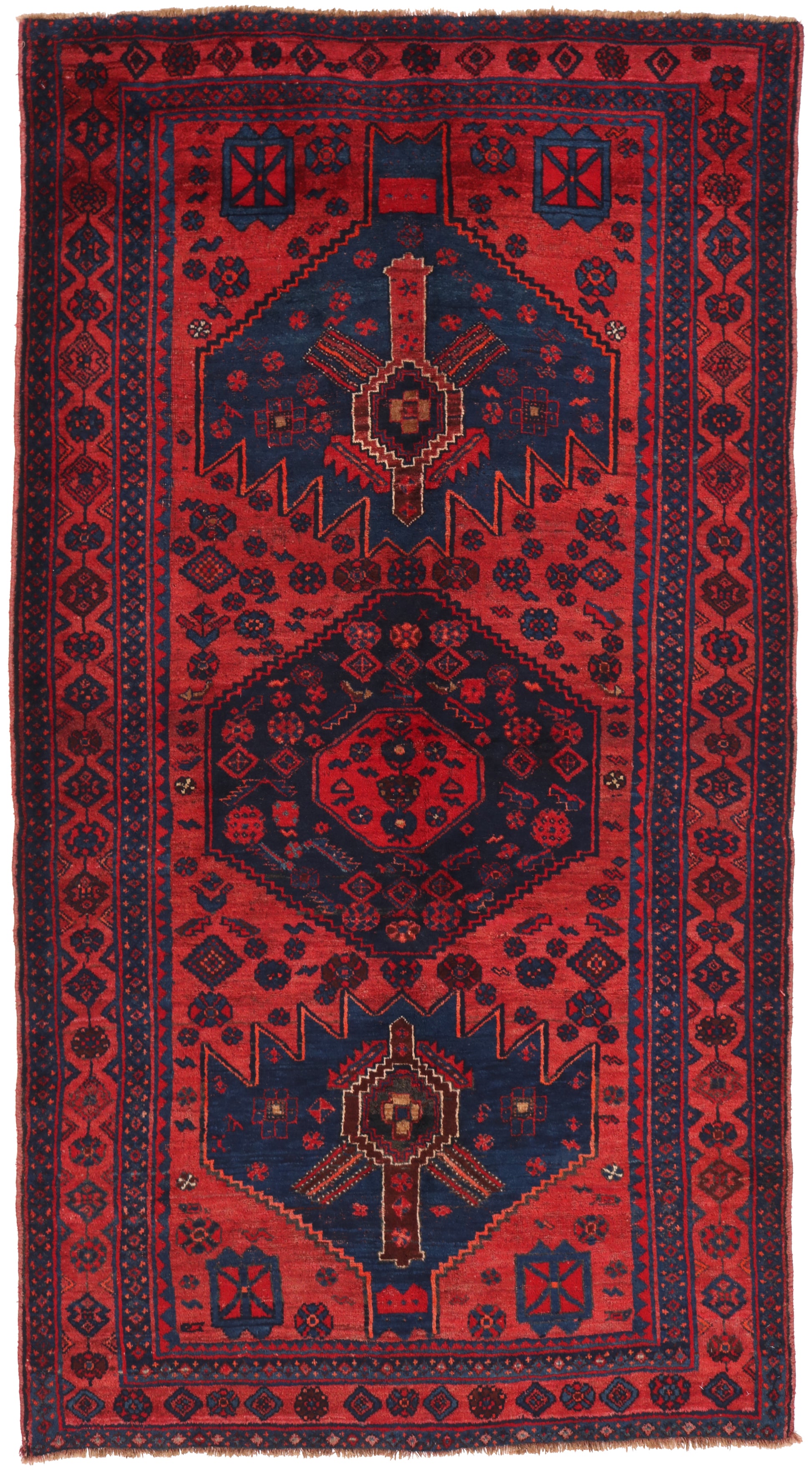 Red and blue patterned rug with geometric design