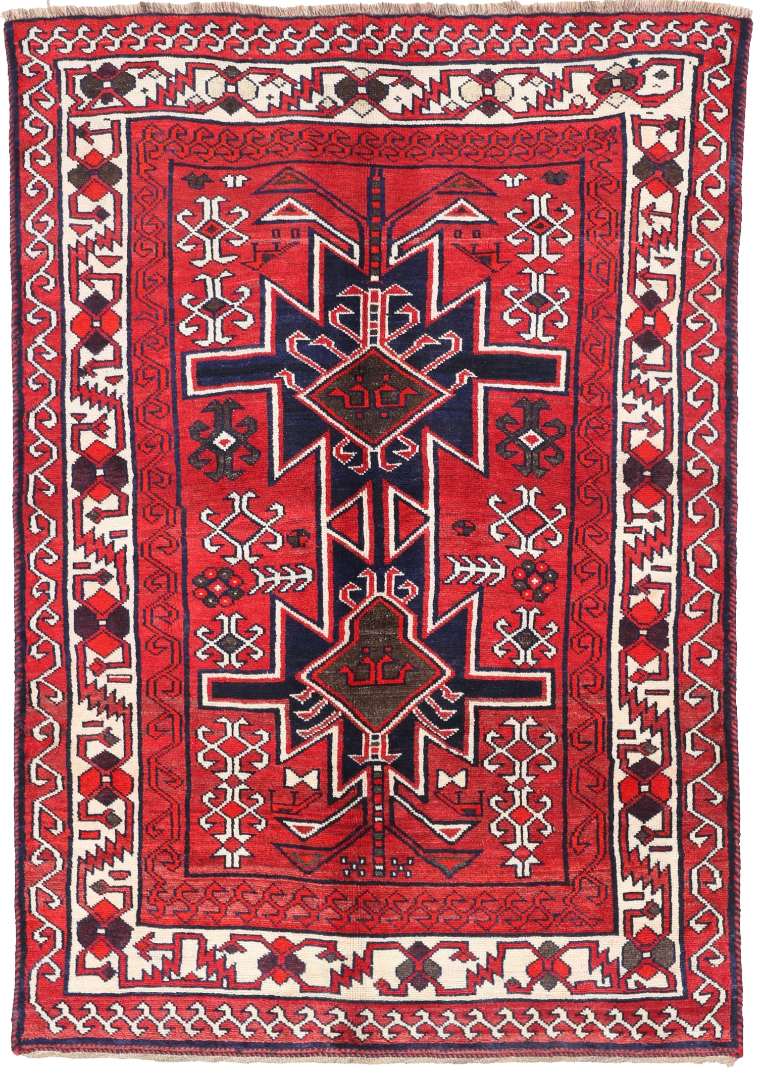 Hand-knotted traditional rug featuring a bold geometric medallion in vibrant red and navy blue, 220x153cm for 5-day event hire.