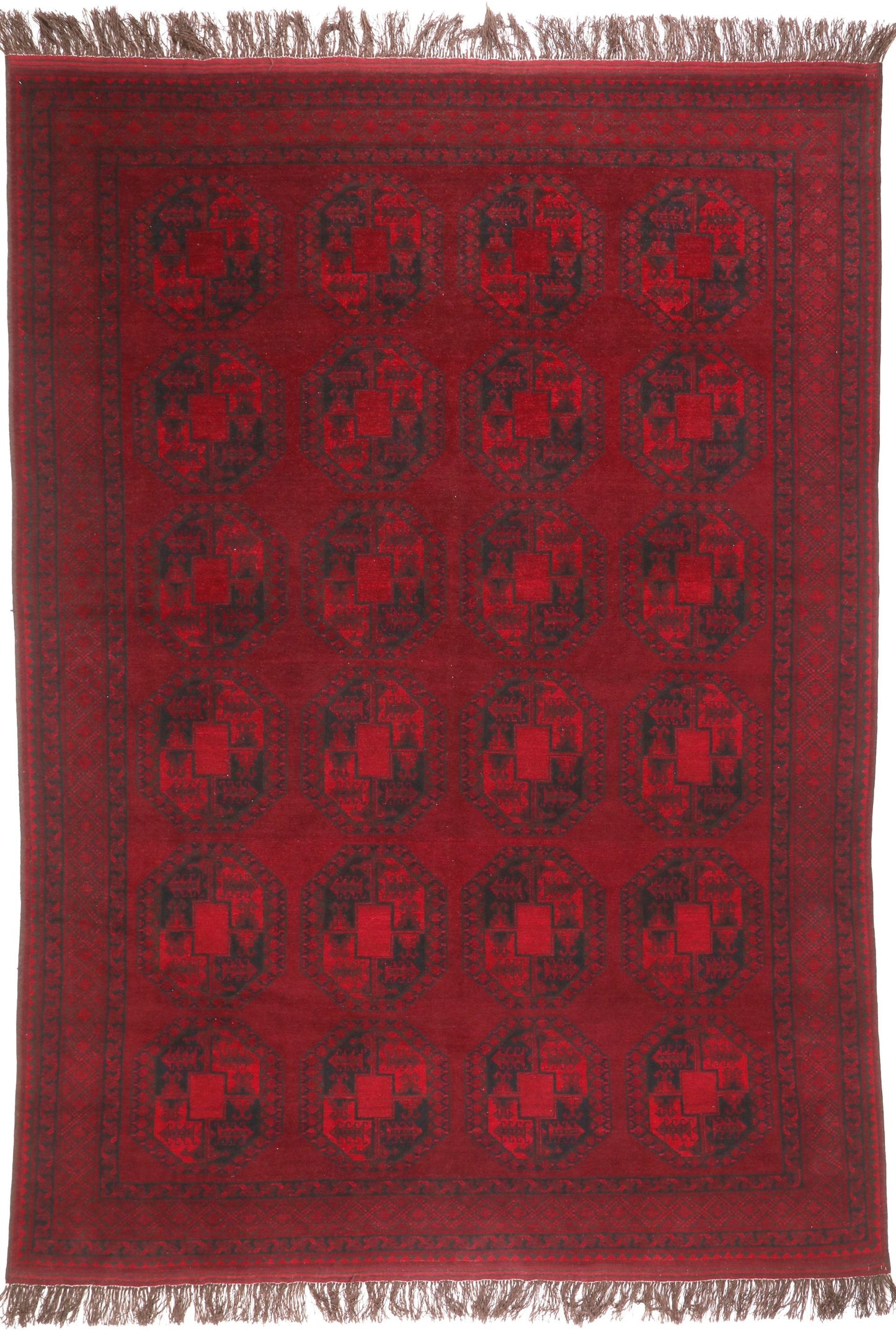 Red patterned rug with black geometric design on a plain background
