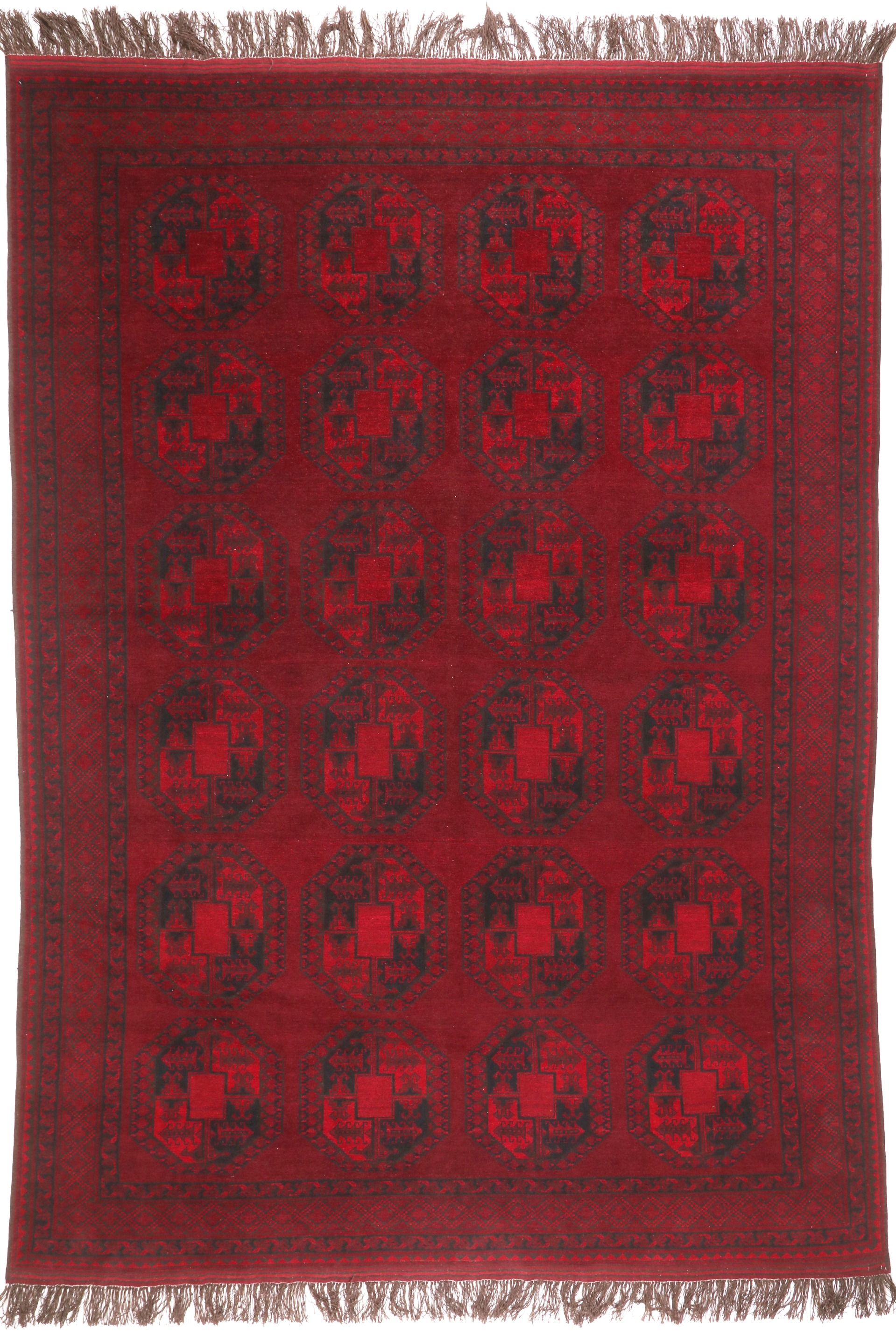 Red patterned rug with black geometric design on a plain background