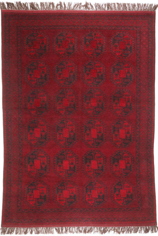 Red patterned rug with black geometric design on a plain background