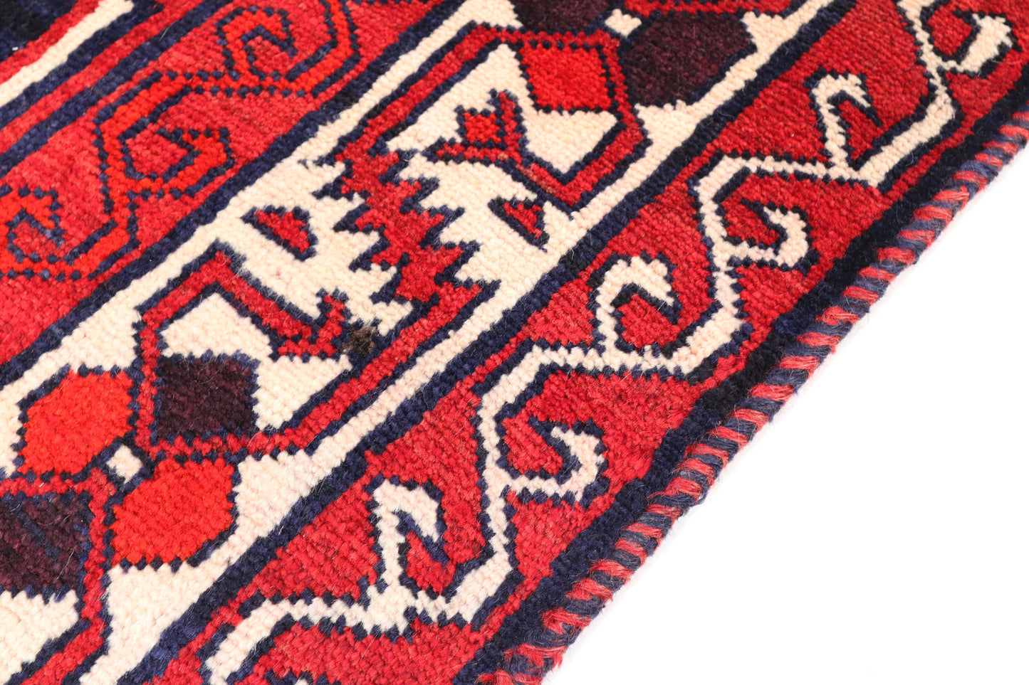 Close-up of a red and white patterned rug