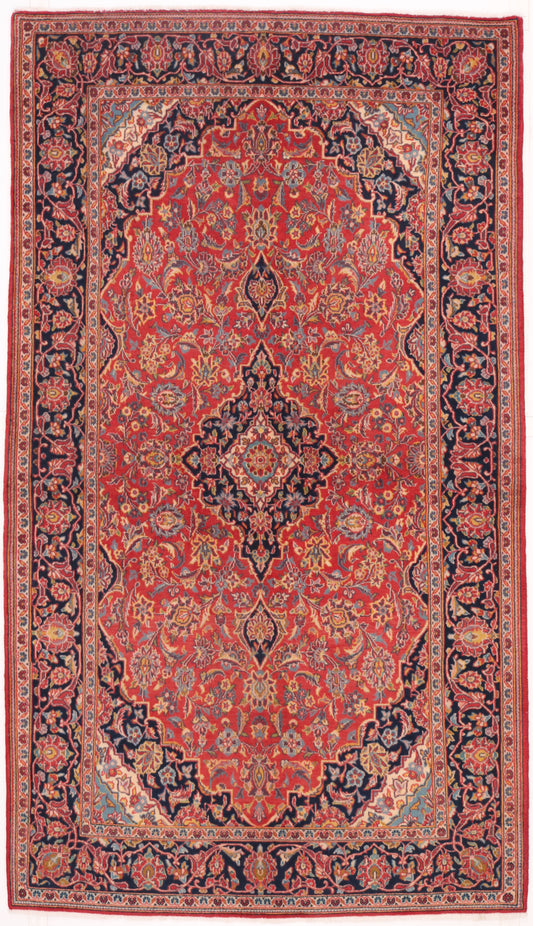 Traditional hand-knotted Persian wool rug in ruby red and navy blue with an intricate floral medallion design, 235x136cm for 5-day event hire.