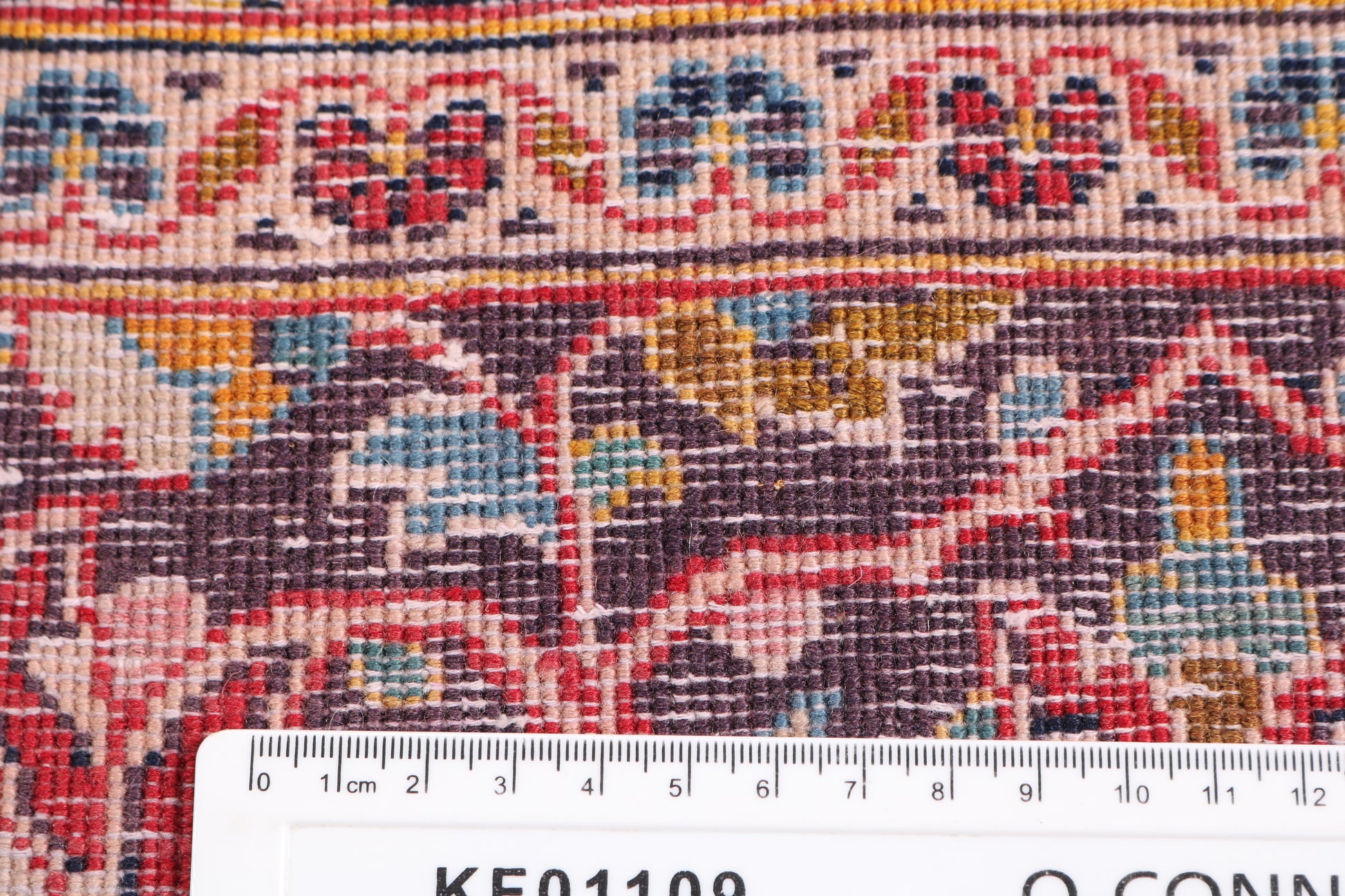 Close-up of the hand-knotted wool pile and knot density for traditional rug, confirming authentic craftsmanship for professional rental.