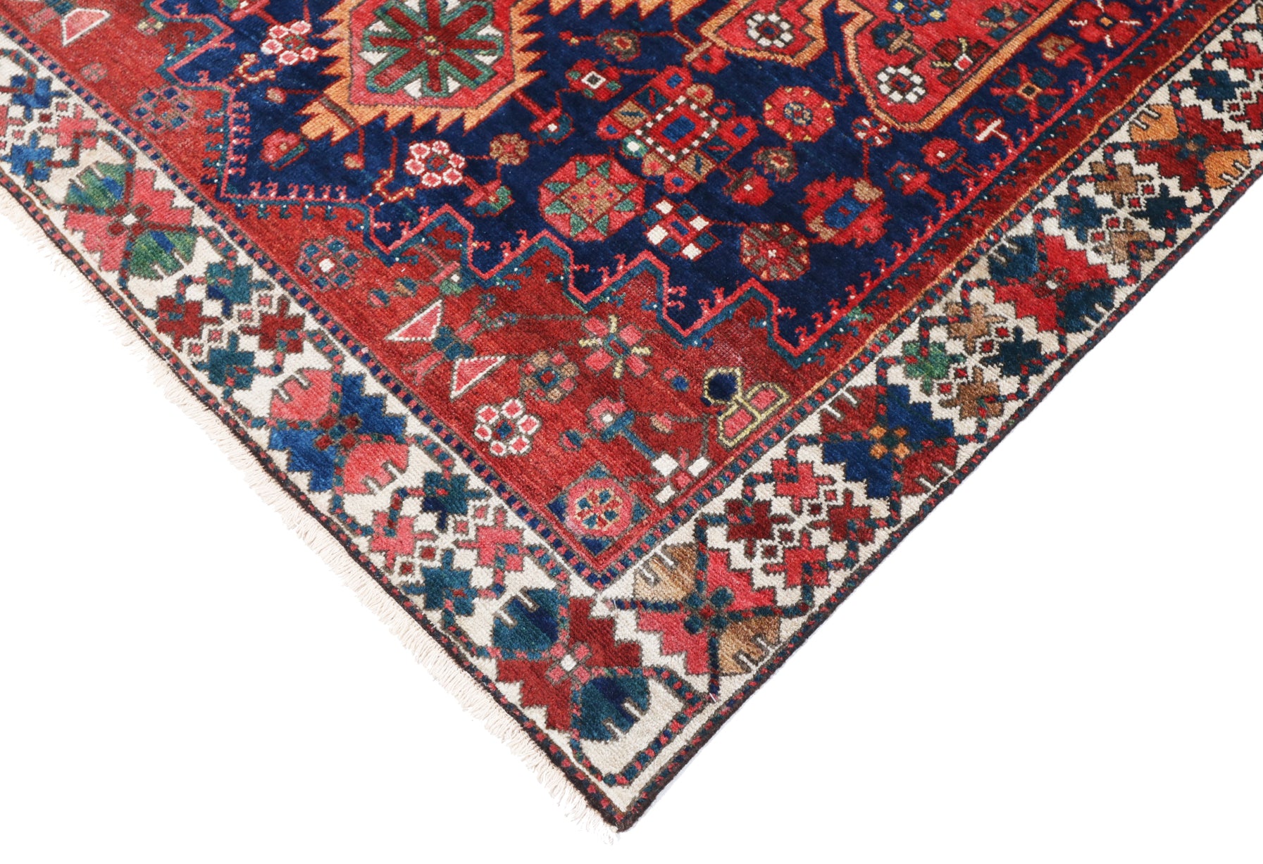 Close-up of a colorful patterned rug with red, blue, and multicolor design.